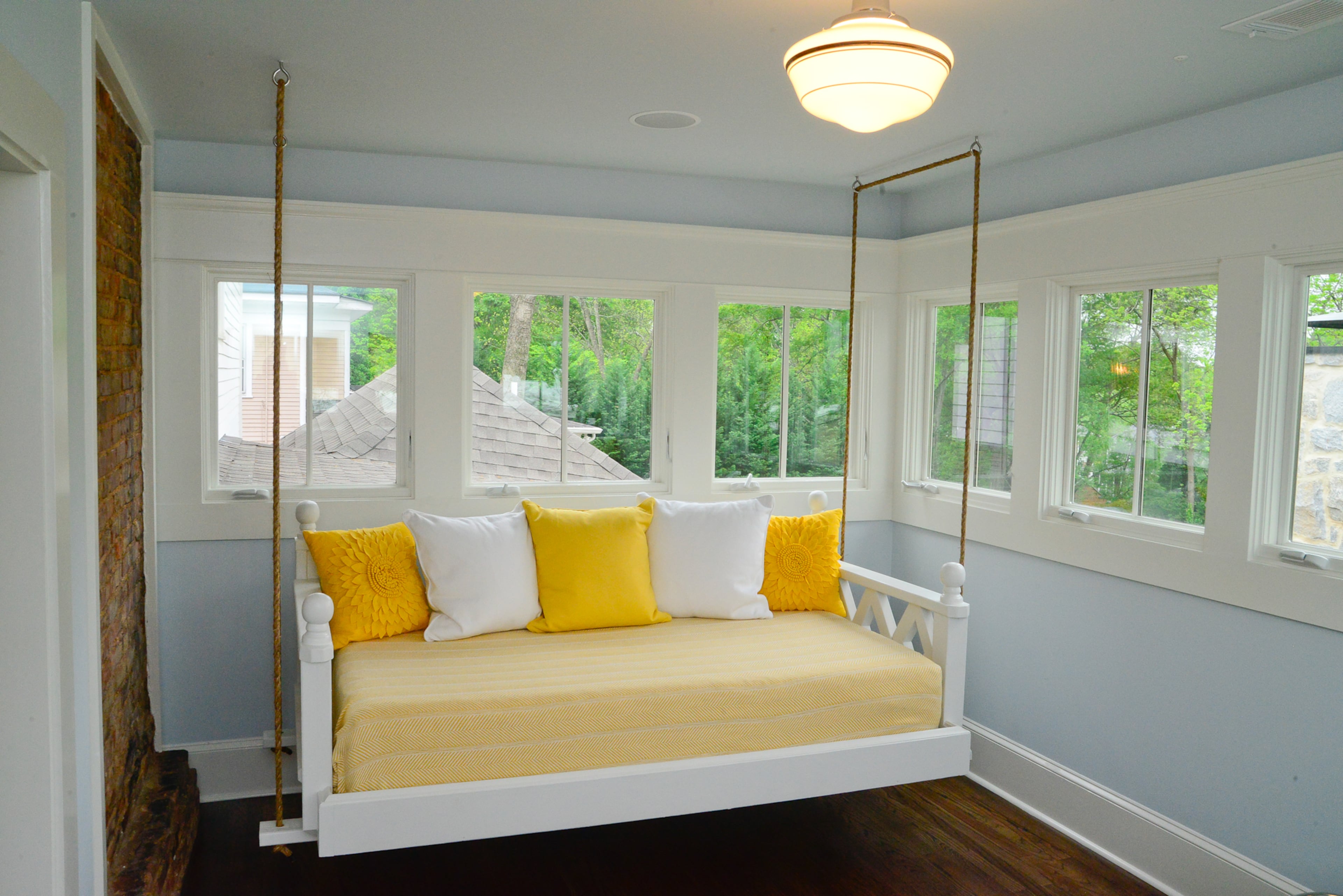 A favorite spot in the Kirkwood home is the sleeping porch facing the Atlanta skyline, with a custom daybed swing.