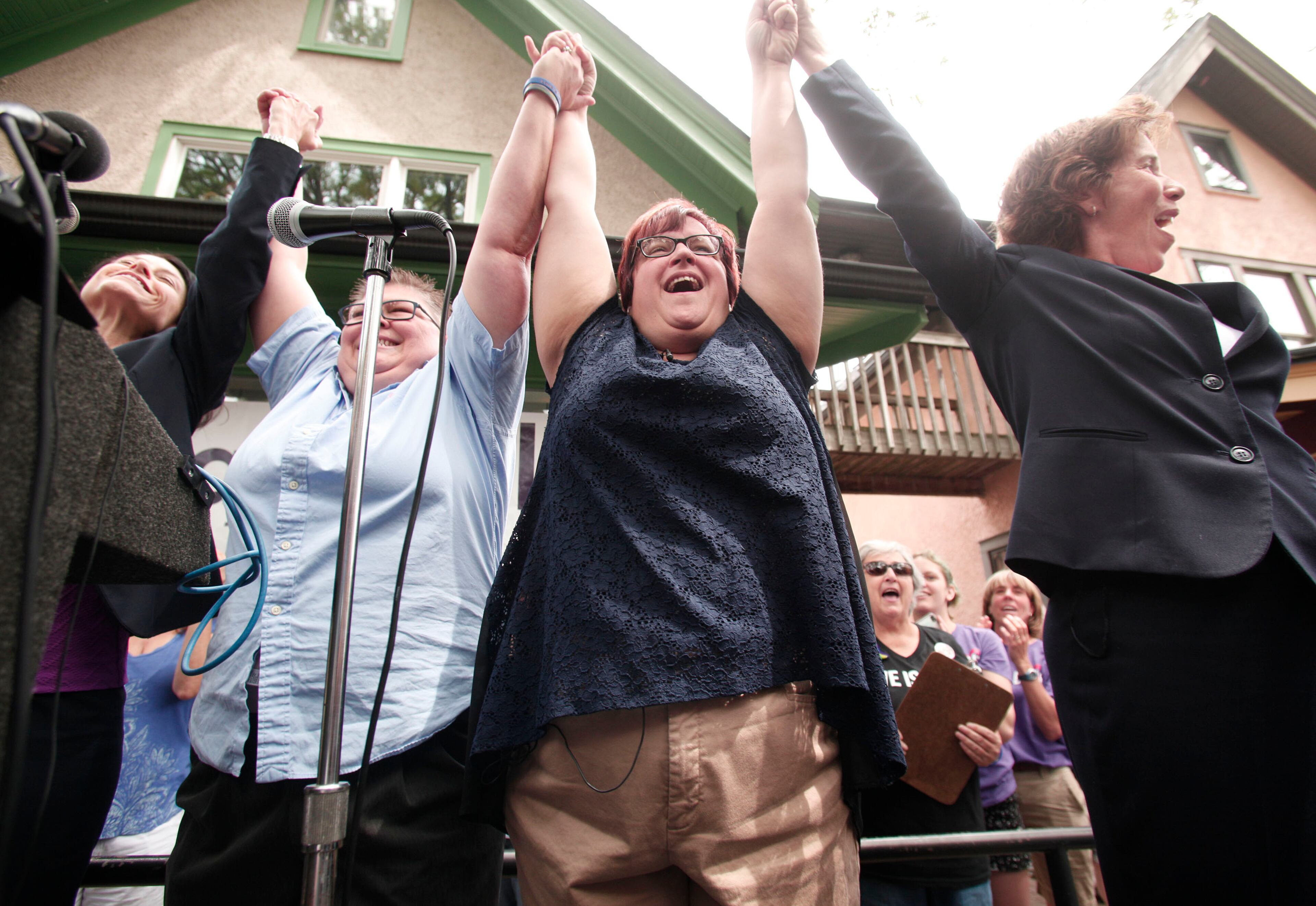 ANN ARBOR, MI - JUNE 26: April DeBoer (C) and Jayne Rowse (L), a same-sex couple with four adopted children, celebrate the Supreme Court's ruling on gay marriage at a press conference on June 26, 2015 in Ann Arbor, Michigan. The U.S. Supreme Court ruled that same-sex couples have the right to marry in all 50 states. (Photo by Bill Pugliano/Getty Images)
