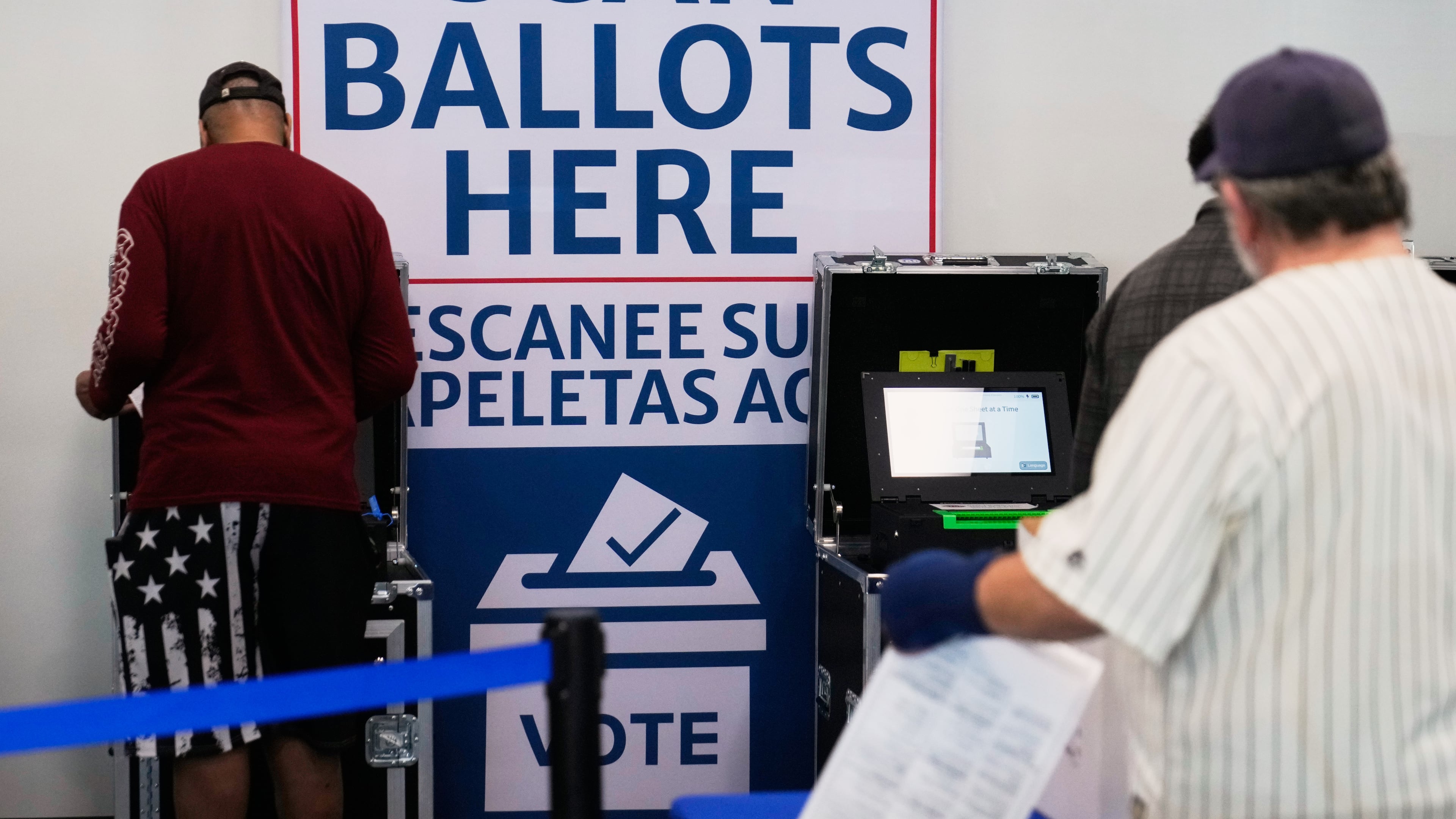 Voters scan their ballots at early in-person voting in Cleveland, Wednesday, Oct. 7, 2026. (AP Photo/Sue Ogrocki)