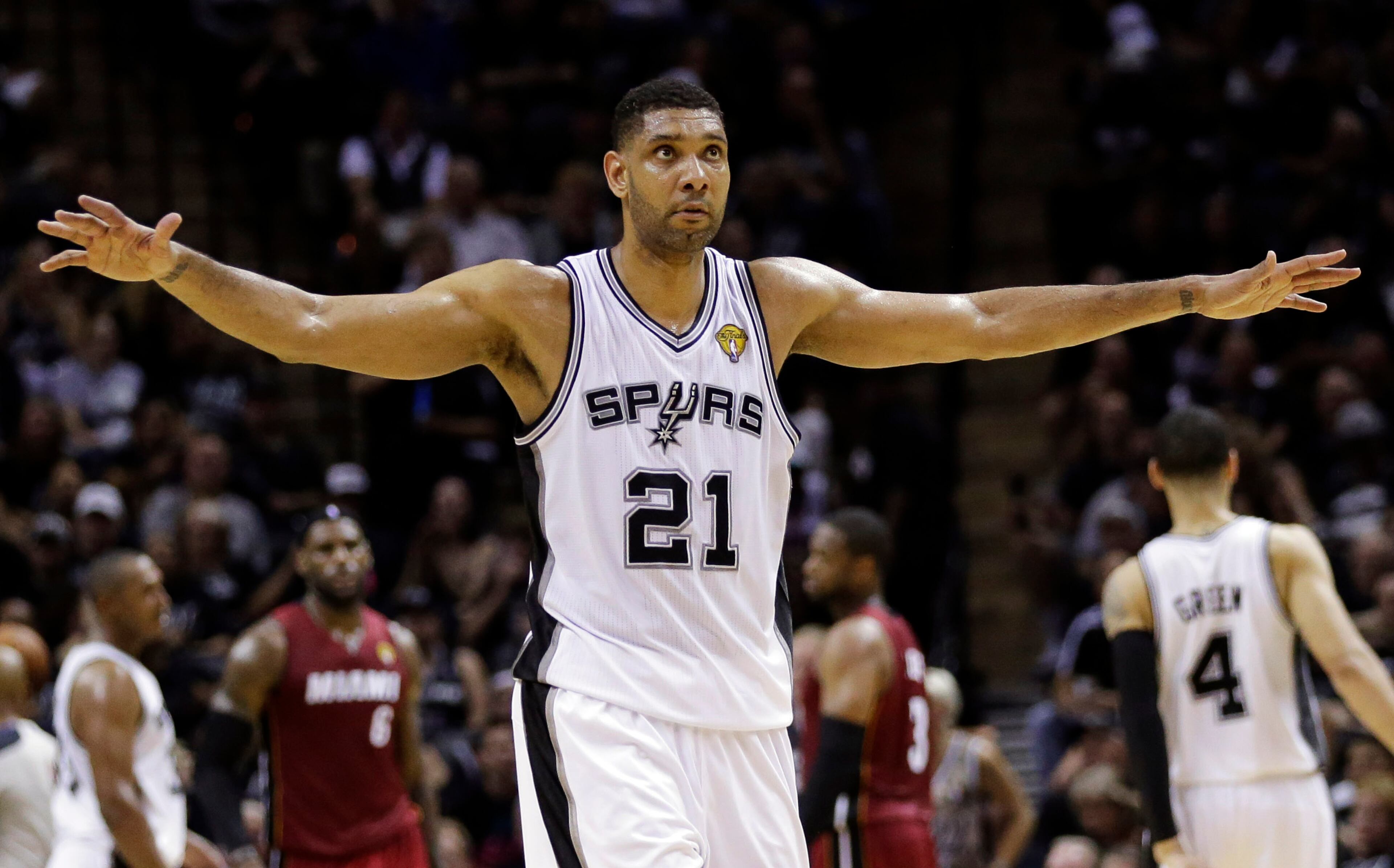 San Antonio Spurs forward Tim Duncan (21) walks down court at a break against the Miami Heat during the first half in Game 1 of the NBA basketball finals on Thursday, June 5, 2014, in San Antonio. (AP Photo/Eric Gay)