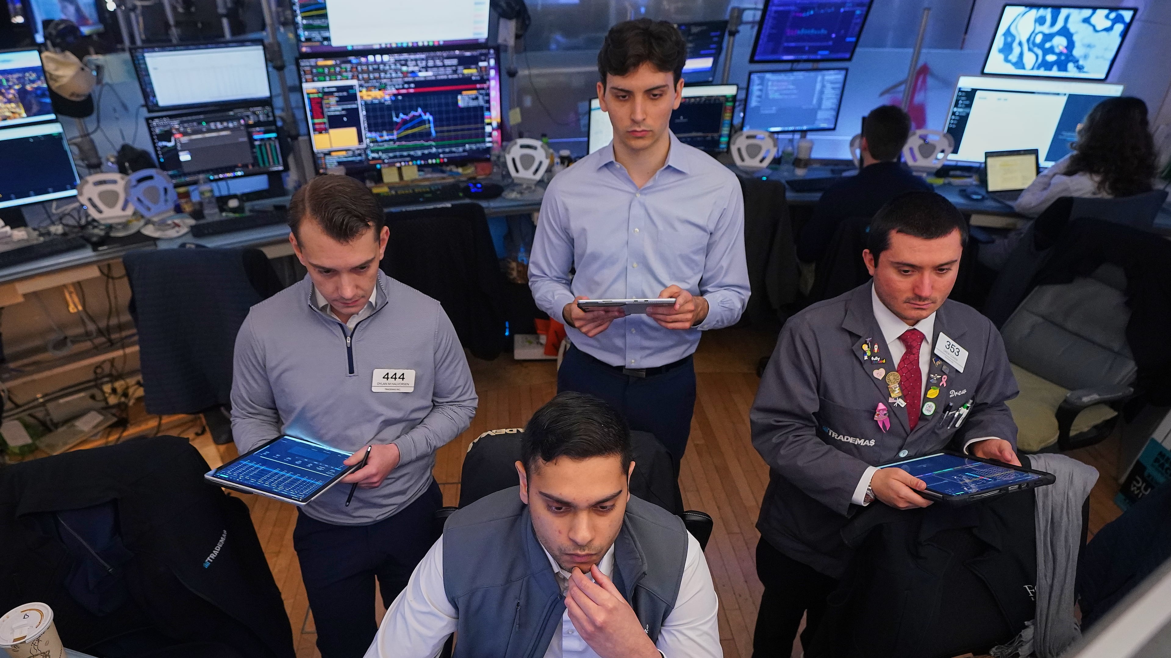 Niall Pawa, foreground center, works with fellow traders on the floor of the New York Stock Exchange, Monday, June 1, 2026. (AP Photo/Richard Drew)