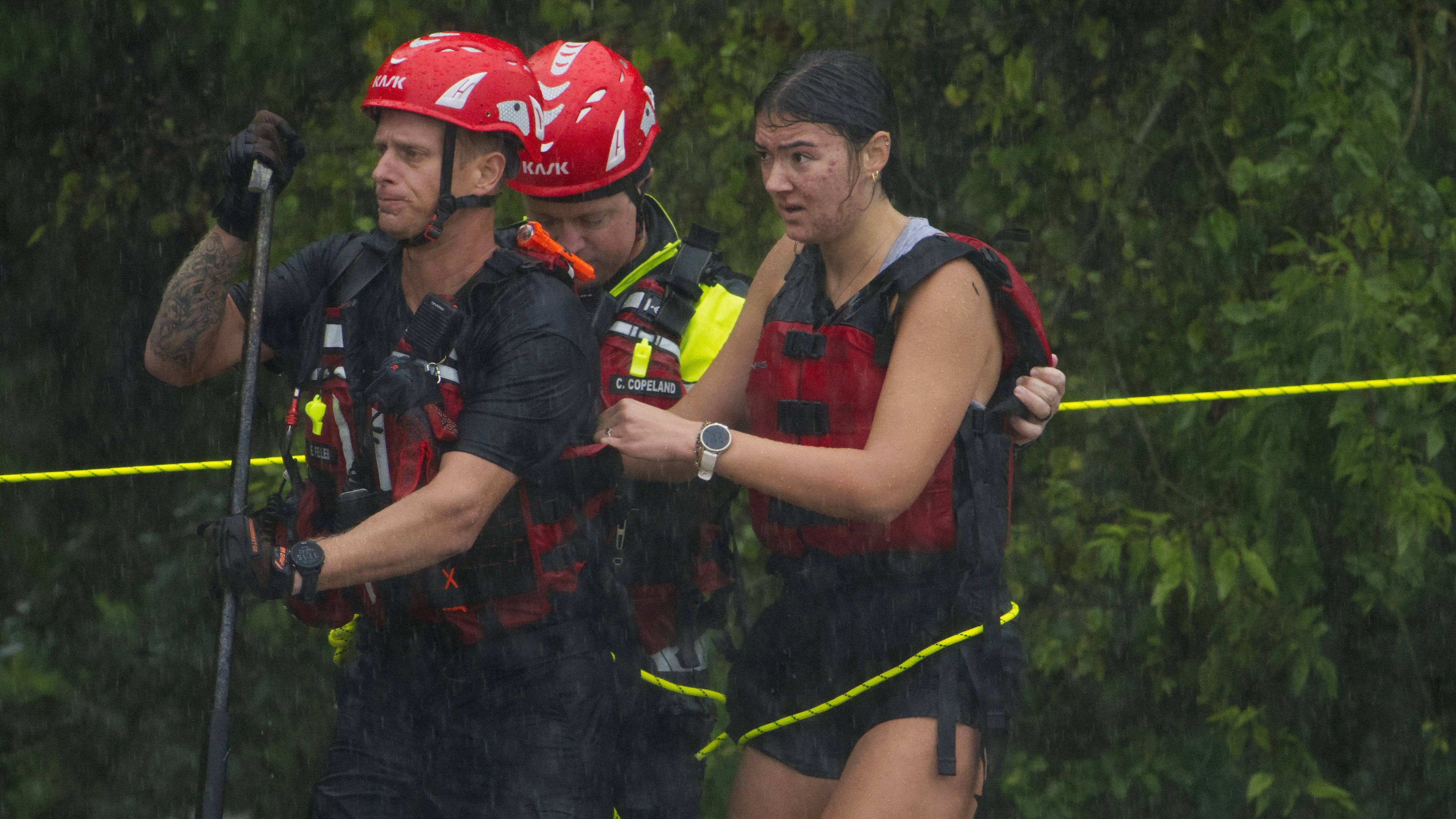 Members of the Boerne Fire Dept. rescue a woman from flood waters on Wednesday, July 15, 2026, in Boerne, Texas. (AP Photo/Darren Abate)