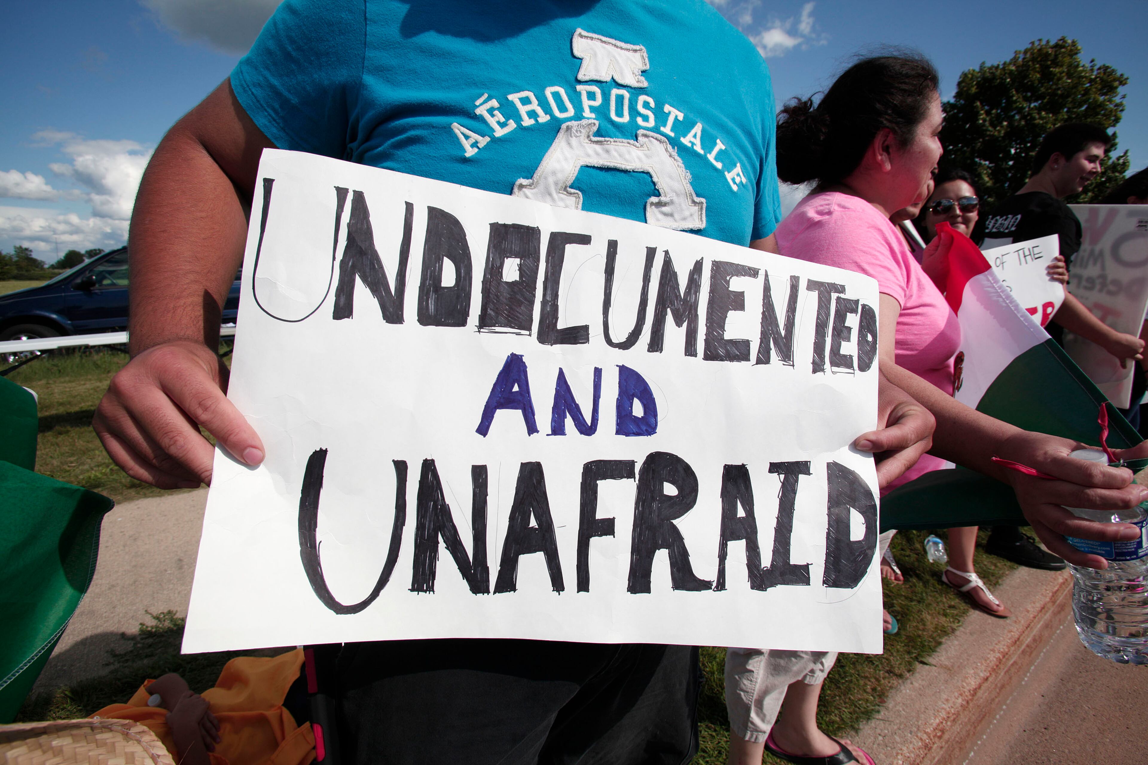 BIRCH RUN, MI - AUGUST 11: People protest the appearance of 2016 Republican presidential candidate Donald Trump at the venue where he will be delivering the keynote address at the Genesee and Saginaw Republican Party Lincoln Day Event August 11, 2015 in Birch Run, Michigan. This is Trump's first campaign event since his Republican debate last week. (Photo by Bill Pugliano/Getty Images)