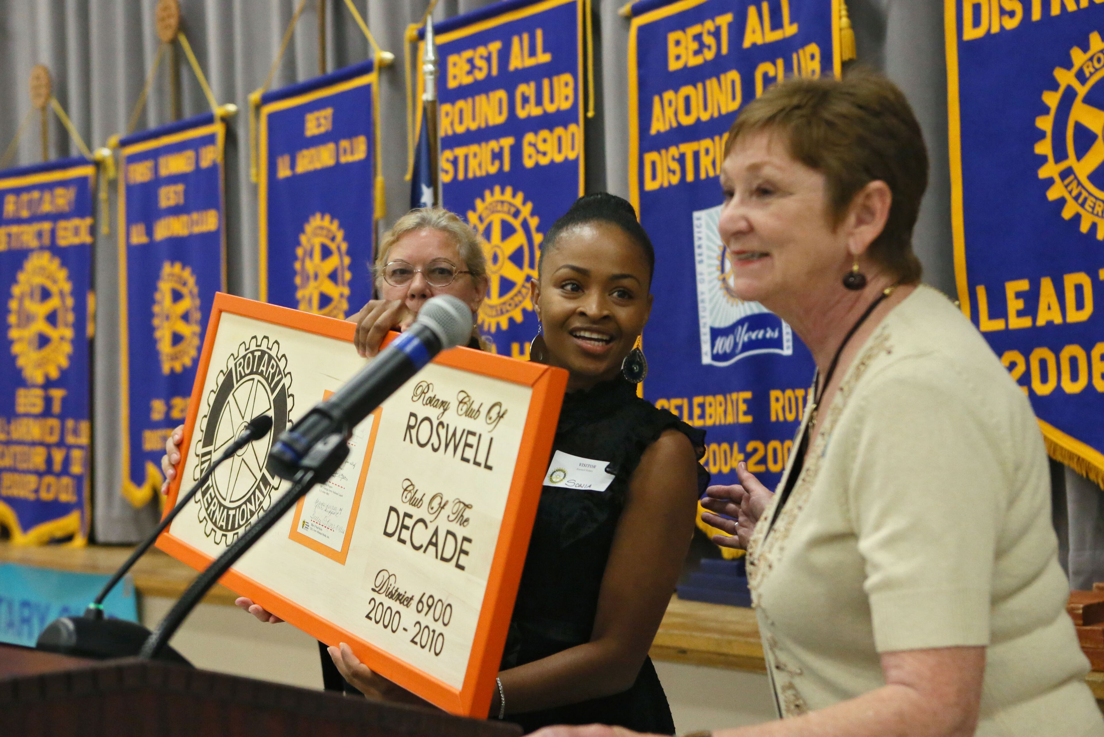 Simon (center) was a guest at a Roswell Rotary meeting, where she presented a thank-you plaque to club President Jacque Digieso and and spoke briefly to the group.