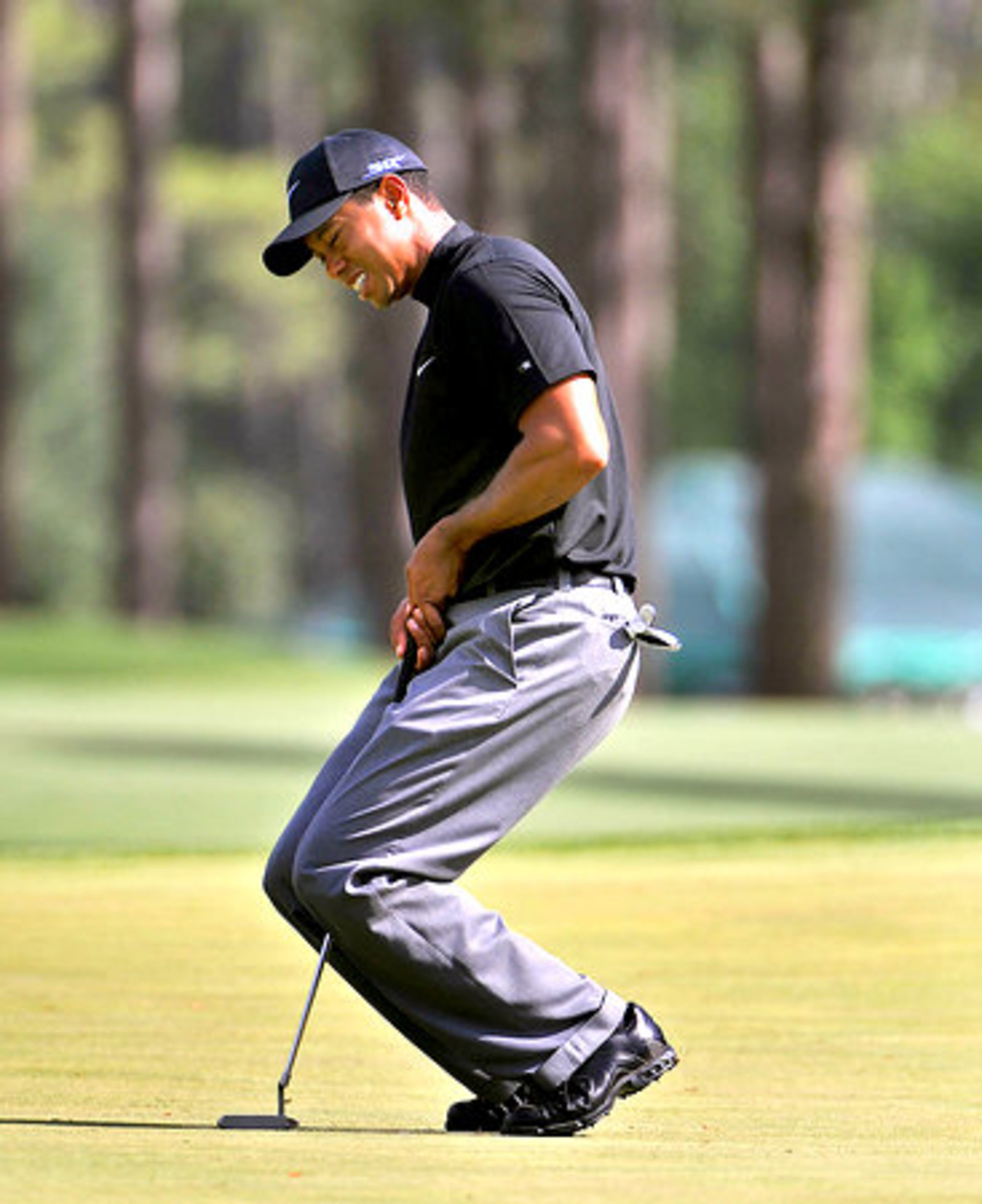 Tiger Woods reacts to missing a putt for eagle on the 8th hole.