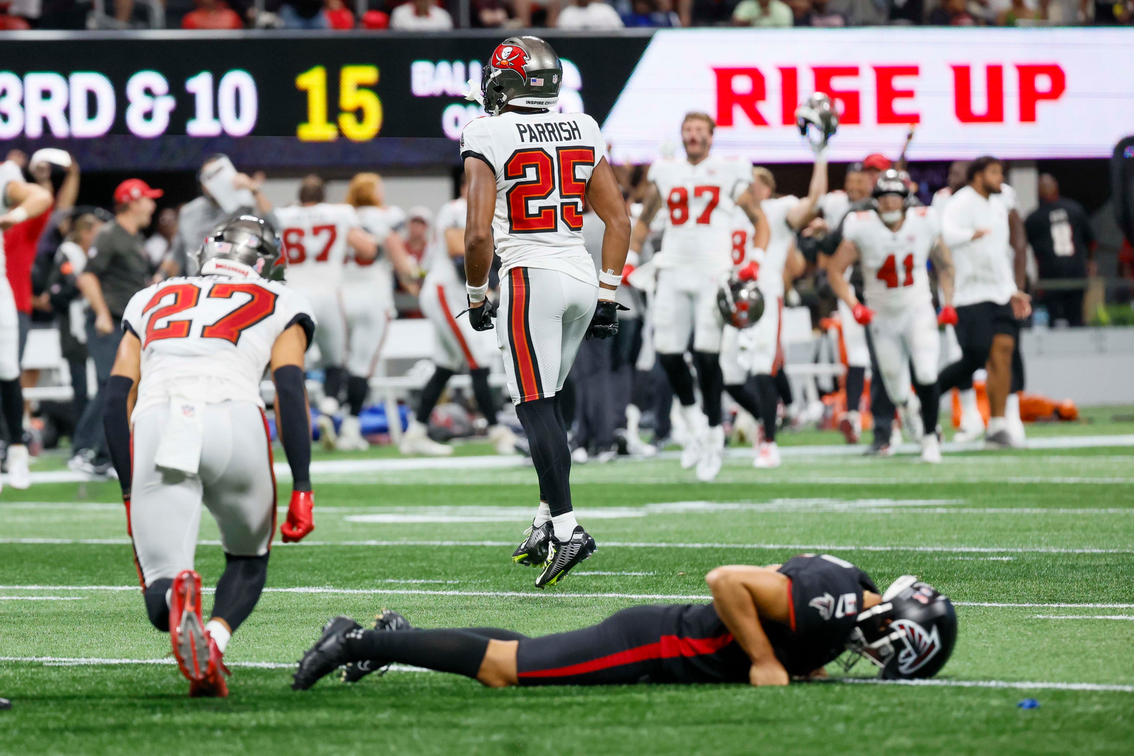 Tampa Bay Buccaneers players celebrate as Atlanta Falcons placekicker Younghoe Koo lies on the ground after missing a last-second field goal. The Atlanta Falcons lost their home opener 23-20 to the Tampa Bay Buccaneers at Mercedes-Benz Stadium on Sunday, September 7, 2025, in Atlanta. (Miguel Martinez/AJC)