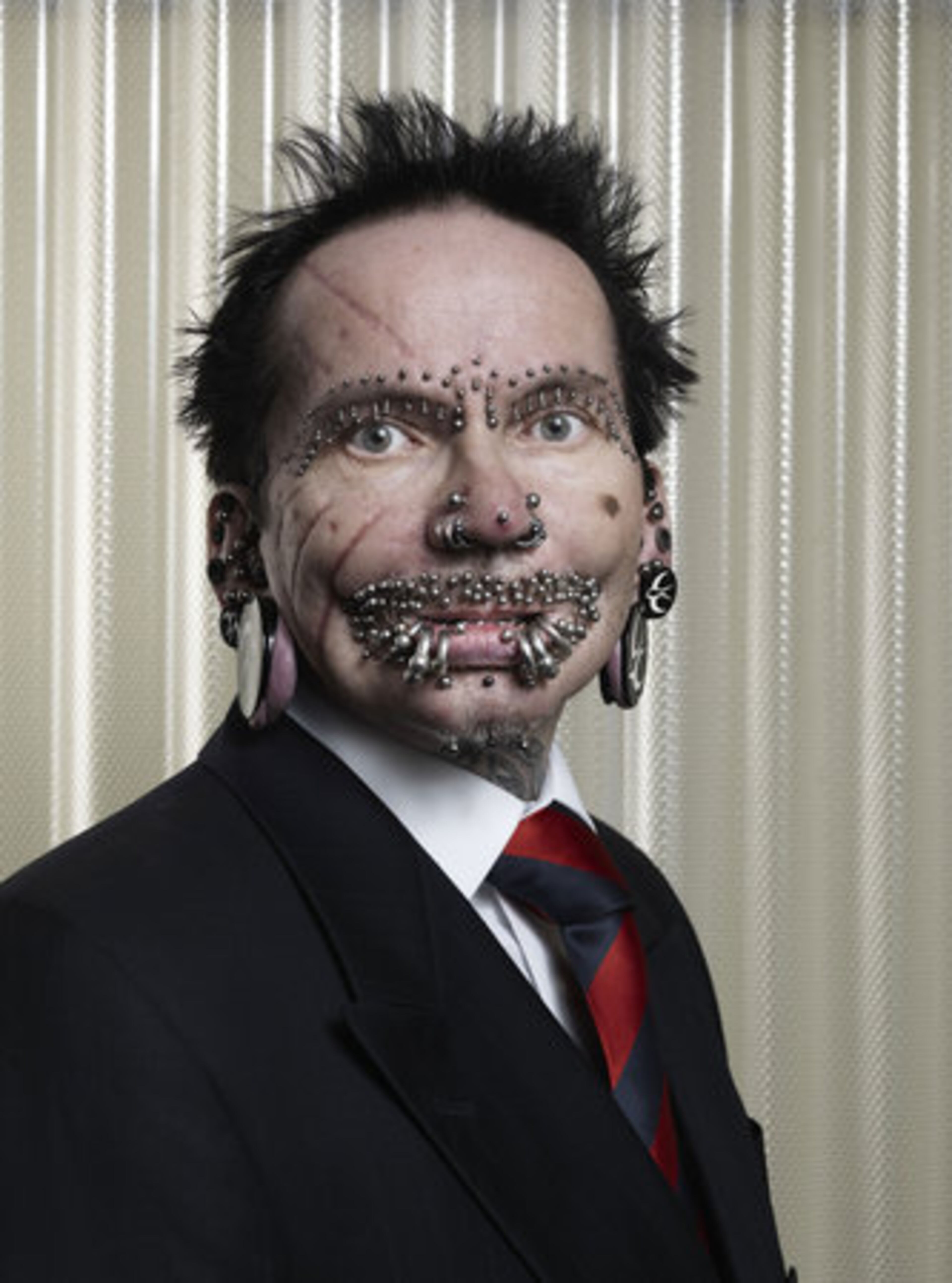 The Guinness World Record holder for "Most Pierced Man" is Rolf Buchholz, who has 453 studs and rings all over his body. Rolf Buchholz, from Dortmund, Germany, has -- among others -- 94 piercings in and around his lips, 25 in his eyebrows, eight in his nose and 278 in his genital area. Buchholz is featured in the Guinness World Records 2012 edition book, available today for $28.95.