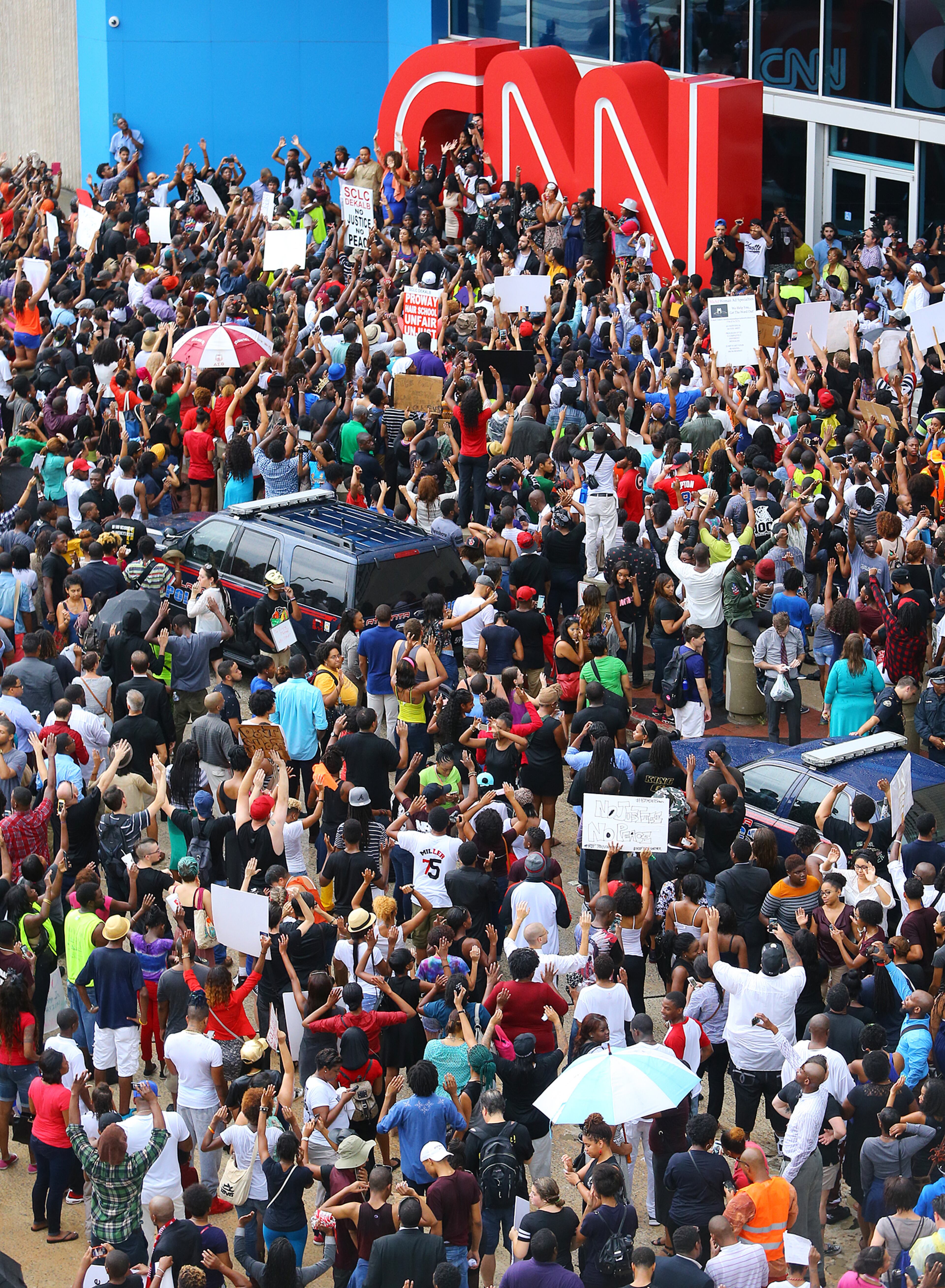 081814 Atlanta: Protesters rally for Mike Brown and Ferguson filling the sidewalks and street outside the CNN Center on Monday, August 18, 2014, in Atlanta. CURTIS COMPTON / CCOMPTON@AJC.COM