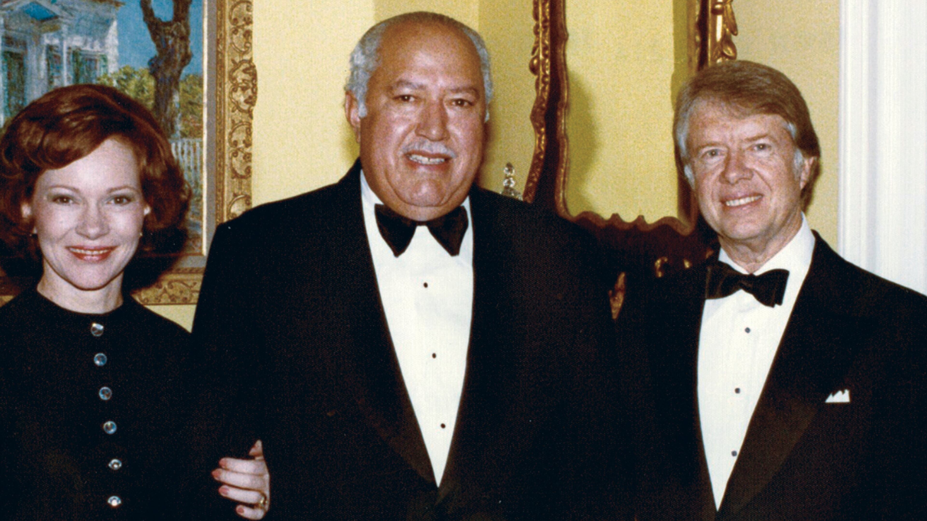 In this undated photo provided by The White House, John Woodson Ficklin poses for a photos with President Jimmy Carter and first lady Rosalynn Carter at the White House in Washington. (The White House via AP)