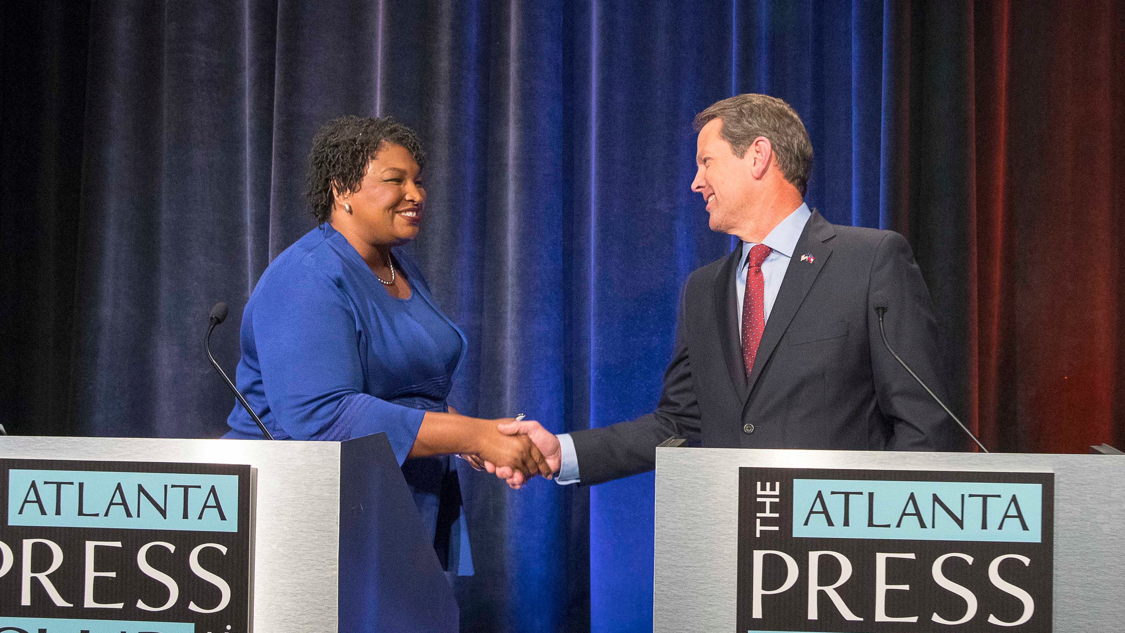 Stacey Abrams and Brian Kemp greet each other before a live taping of the 2018 Gubernatorial debate for the Atlanta Press Club. (ALYSSA POINTER/ALYSSA.POINTER@AJC.COM)