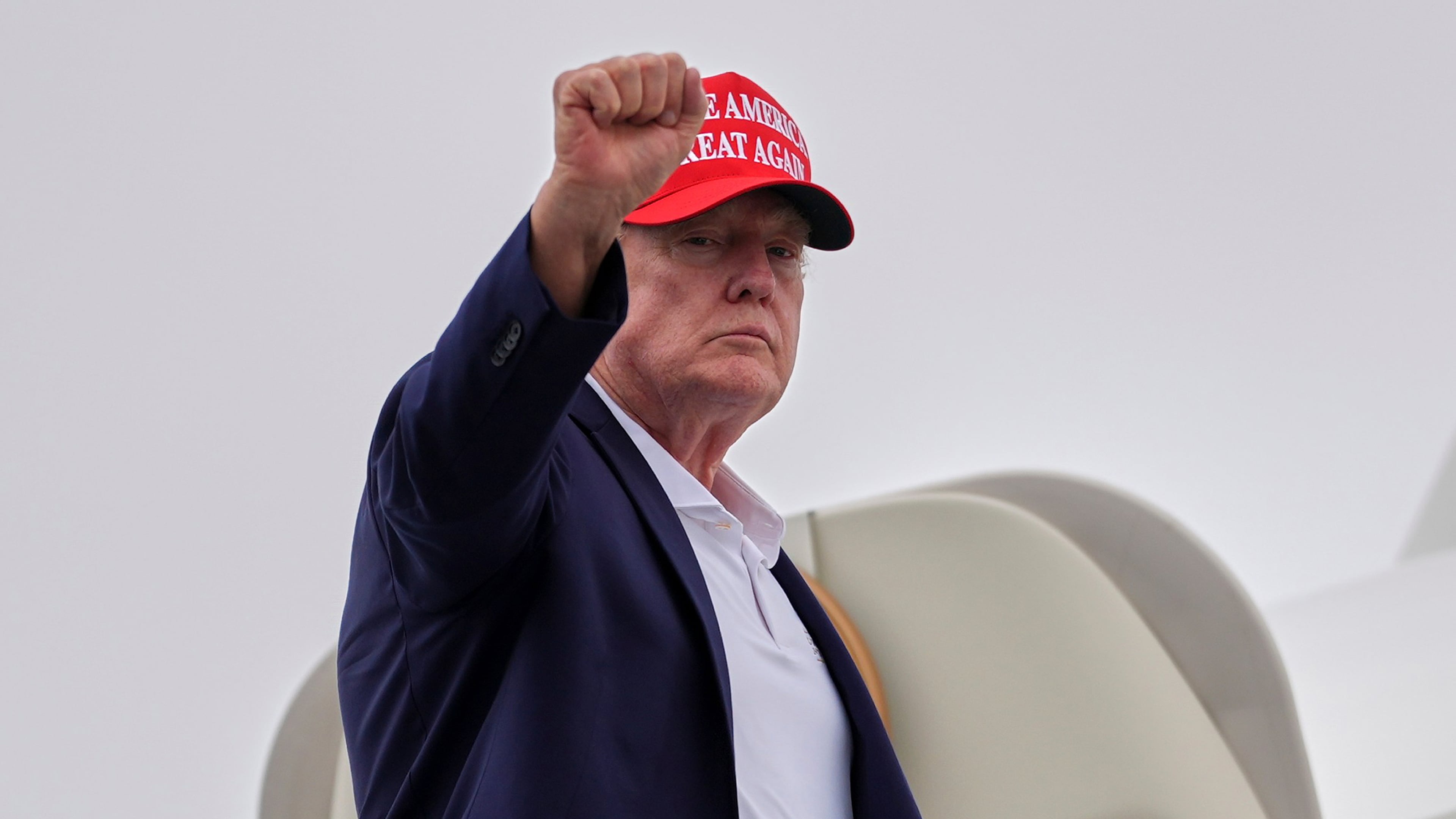 President Donald Trump gestures as he boards Air Force One at Morristown Airport, Sunday, Aug. 16, 2026, in Morristown, N.J. (AP Photo/Julia Demaree Nikhinson)