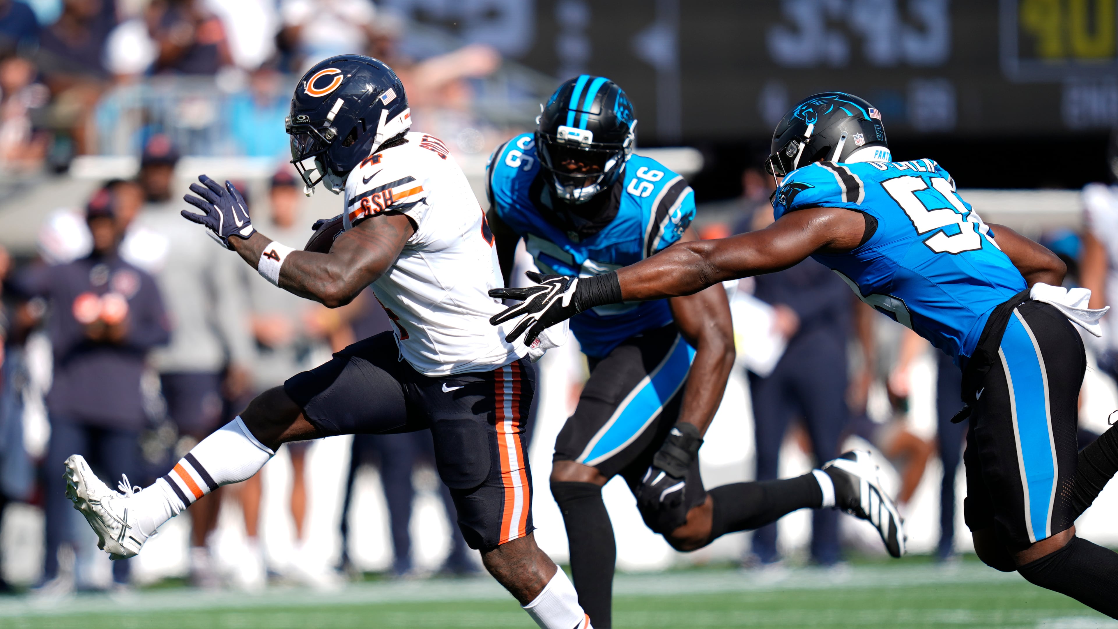 Chicago Bears running back D'Andre Swift (4) runs against Carolina Panthers linebacker Jeremiah Moon (56) and inside linebacker Bobby Okereke (58) to score a touchdown during the second half of an NFL football game, Sunday, Sept. 13, 2026, in Charlotte, N.C. (AP Photo/Erik Verduzco)