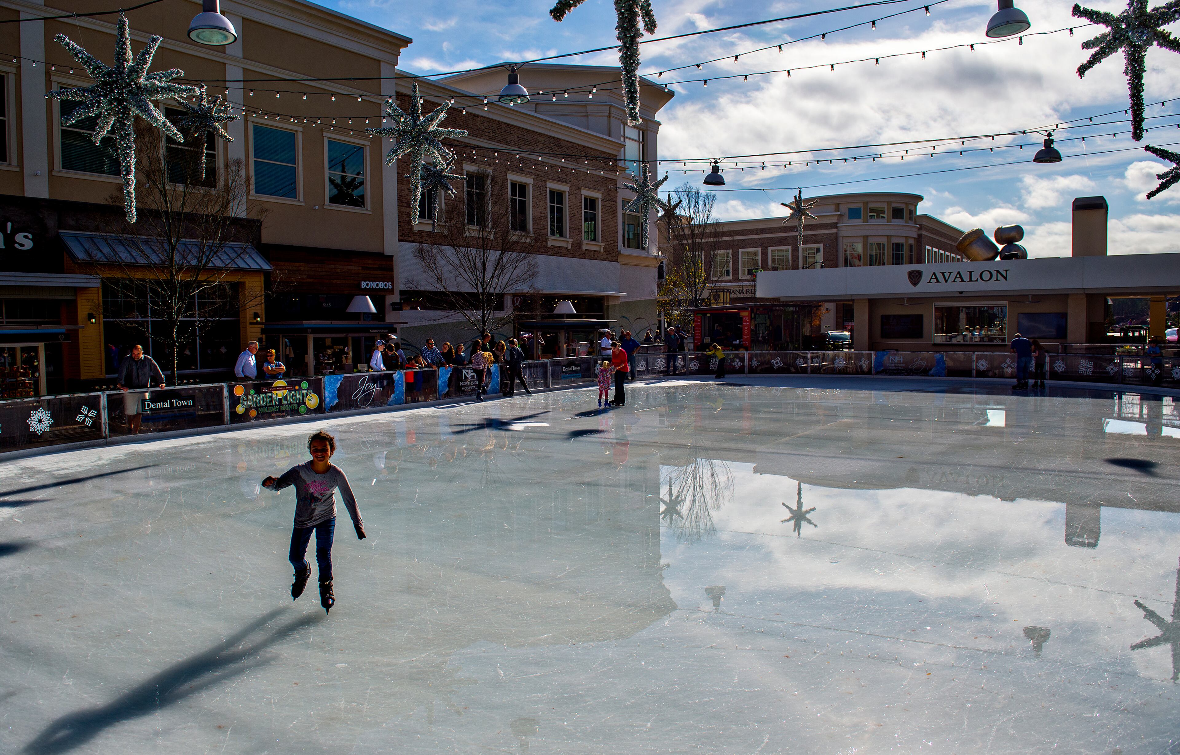 December 26, 2015 Alpharetta - Sophia Martelli (left) skates at the ice rink at Avalon in Alpharetta on Saturday, December 26, 2015. Unseasonably warm weather has caused some rinks around the metro area to close but Avalon is one that has stayed the course. JONATHAN PHILLIPS / SPECIAL
