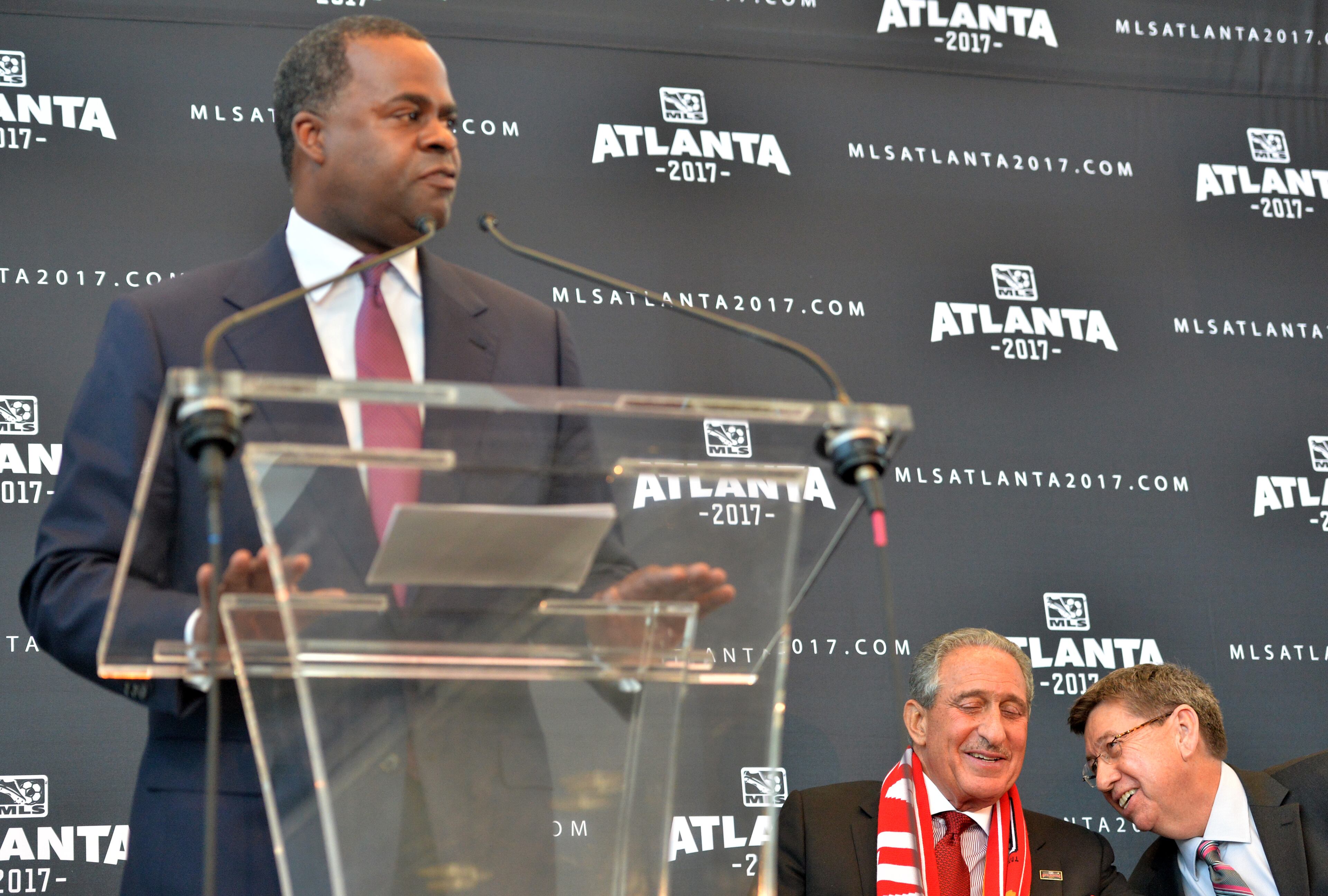 Atlanta mayor Kasim Reed speaks as Falcons owner Arthur Blank and executive director of GWCC Frank Poe talk during the official announcement event in downtown Atlanta on Wednesday, April 16, 2014. MLS commissioner Don Garber, Blank, Reed, Poe and others officially announced that Atlanta will be the 22nd team in MLS on Wednesday downtown amidst a parade-like atmosphere. HYOSUB SHIN / HSHIN@AJC.COM