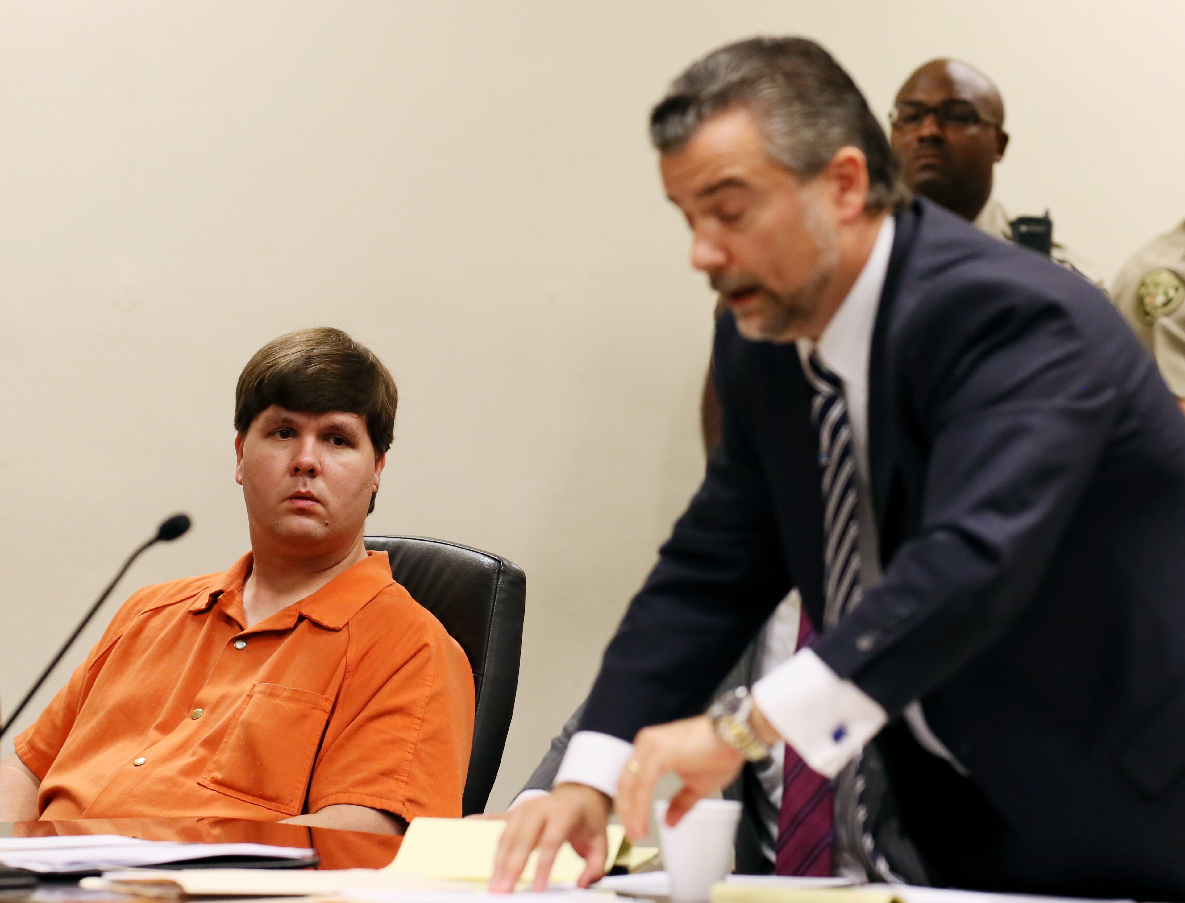 Justin Ross Harris, left, the father of a toddler who died after police say he was left in a hot car for about seven hours, looks on as defense attorney Maddox Kilgore speaks during his bond hearing in Cobb County Magistrate Court, Thursday, July 3, 2014, in Marietta, Ga. (AP Photo/Marietta Daily Journal, Kelly J. Huff, Pool)