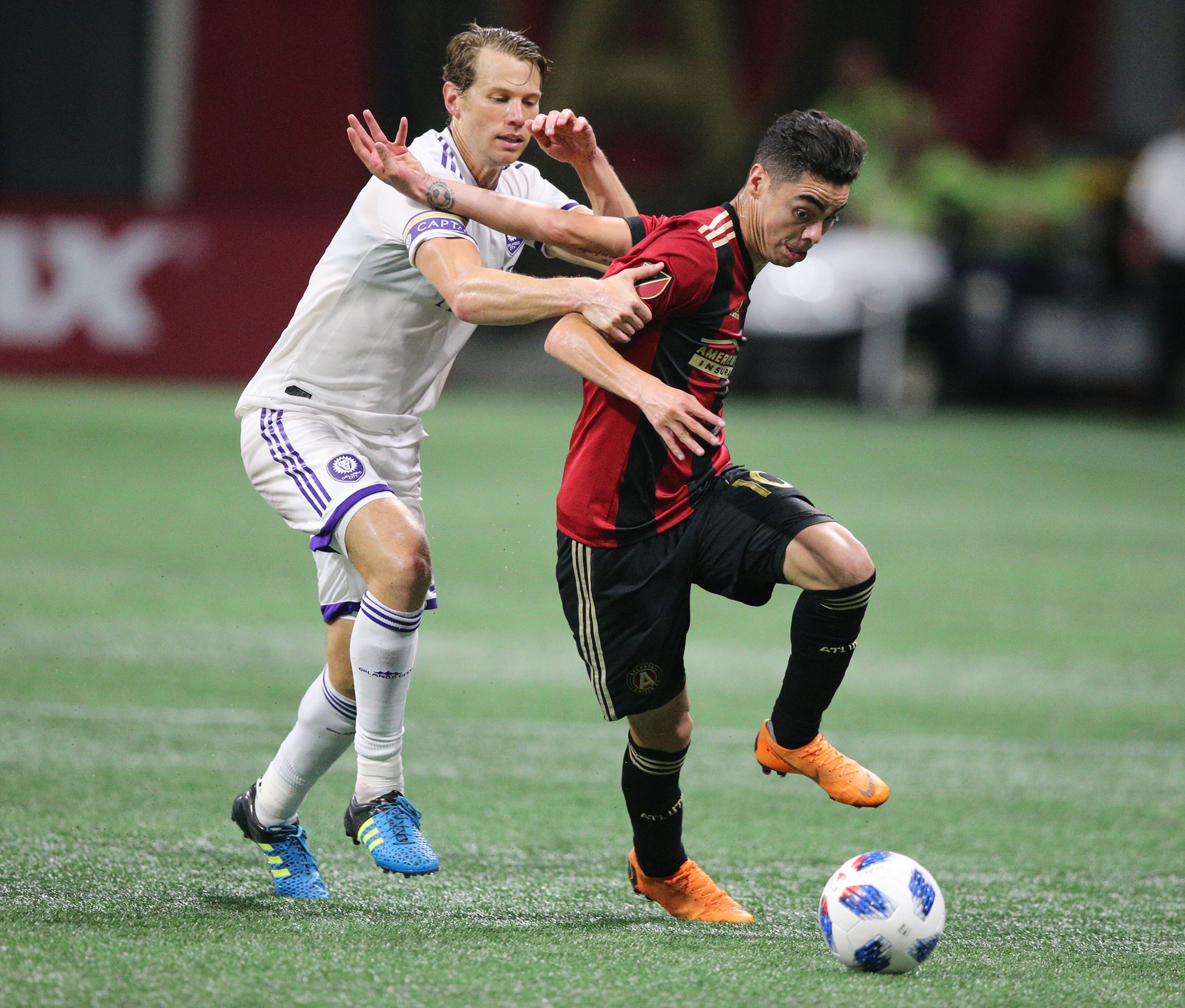 June 30, 2018 Atlanta: Atlanta United Miguel Almiron gets past an Orlando City defender on his way to his second goal of the match during the second half in a MLS soccer match on Saturday, June 30, 2018, in Atlanta. Curtis Compton/ccompton@ajc.com