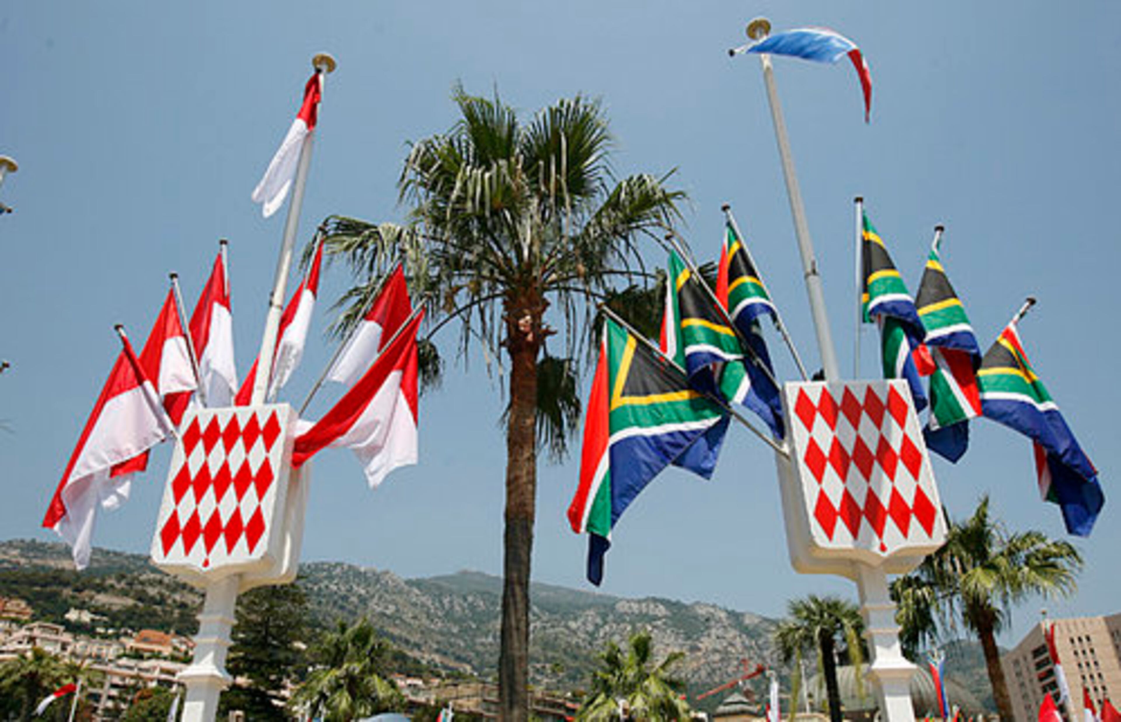 Flags of Monaco join those of South Africa, in honor of Charlene Wittstock, the former Olympic swimmer from that country who will marry Prince Albert II. Albert is also a former Olympian, competing in bobsled.
