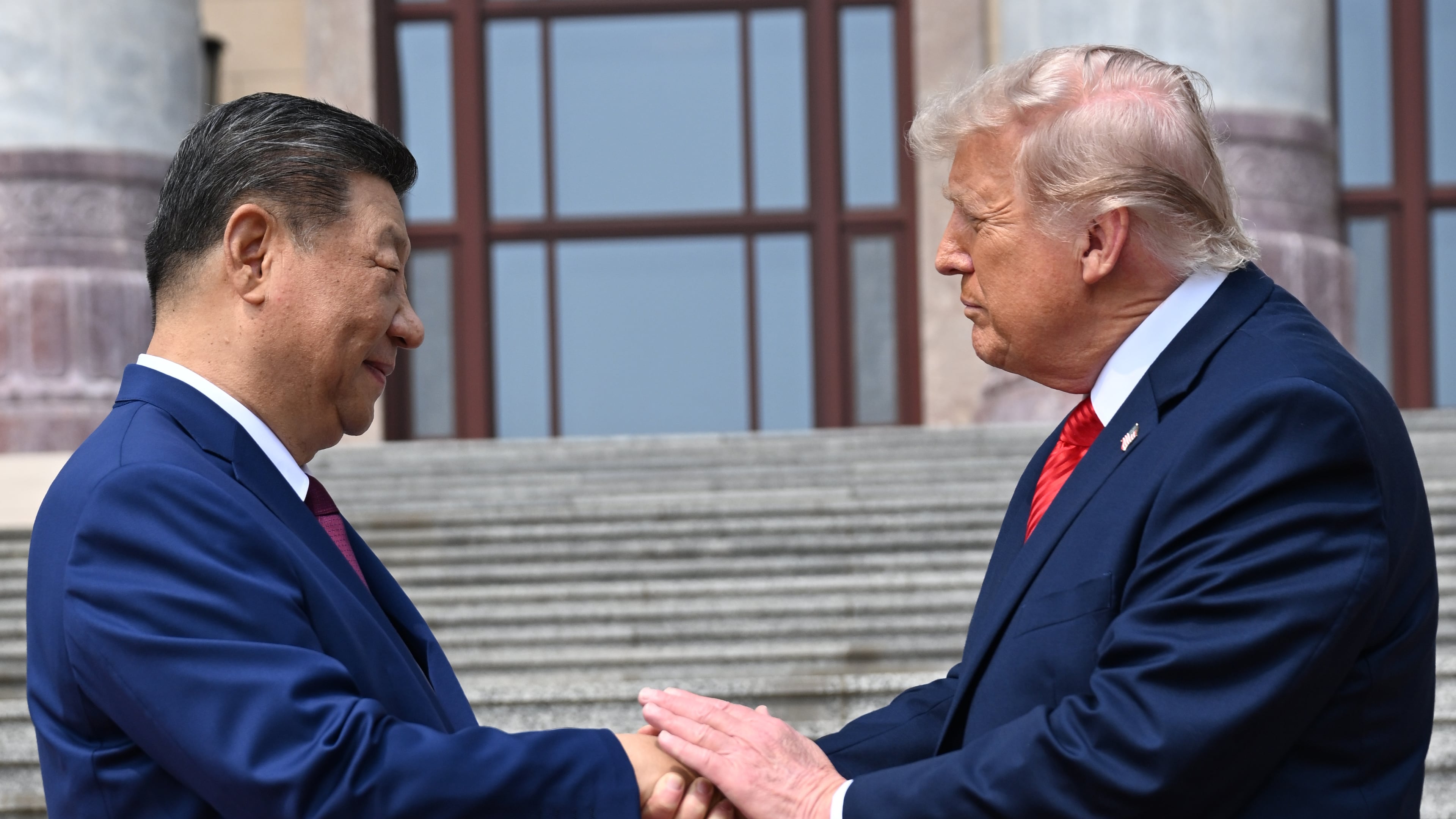 FILE - Chinese President Xi Jinping, left, shakes hands with President Donald Trump at the Great Hall of the People in Beijing, May 14, 2026. (Kenny Holston/Pool Photo via AP, file)