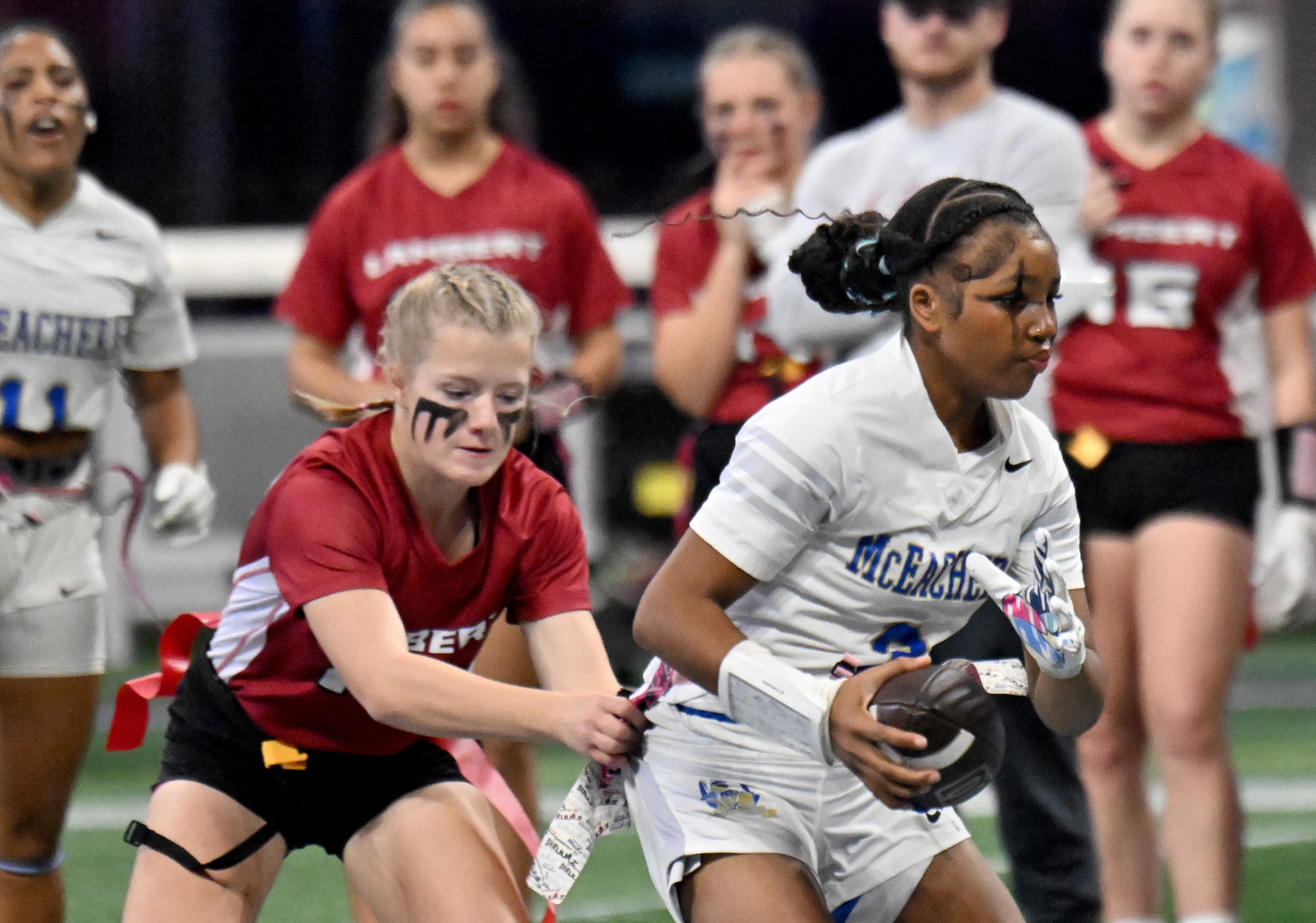 McEachern's Ava Couzens (3) runs for a first down during the first half in GHSA Division 4 Flag Football State Championship game at Mercedes-Benz Stadium, Wednesday, December 18, 2024, in Atlanta. McEachern won 26-6 over Lambert. (Hyosub Shin / AJC)