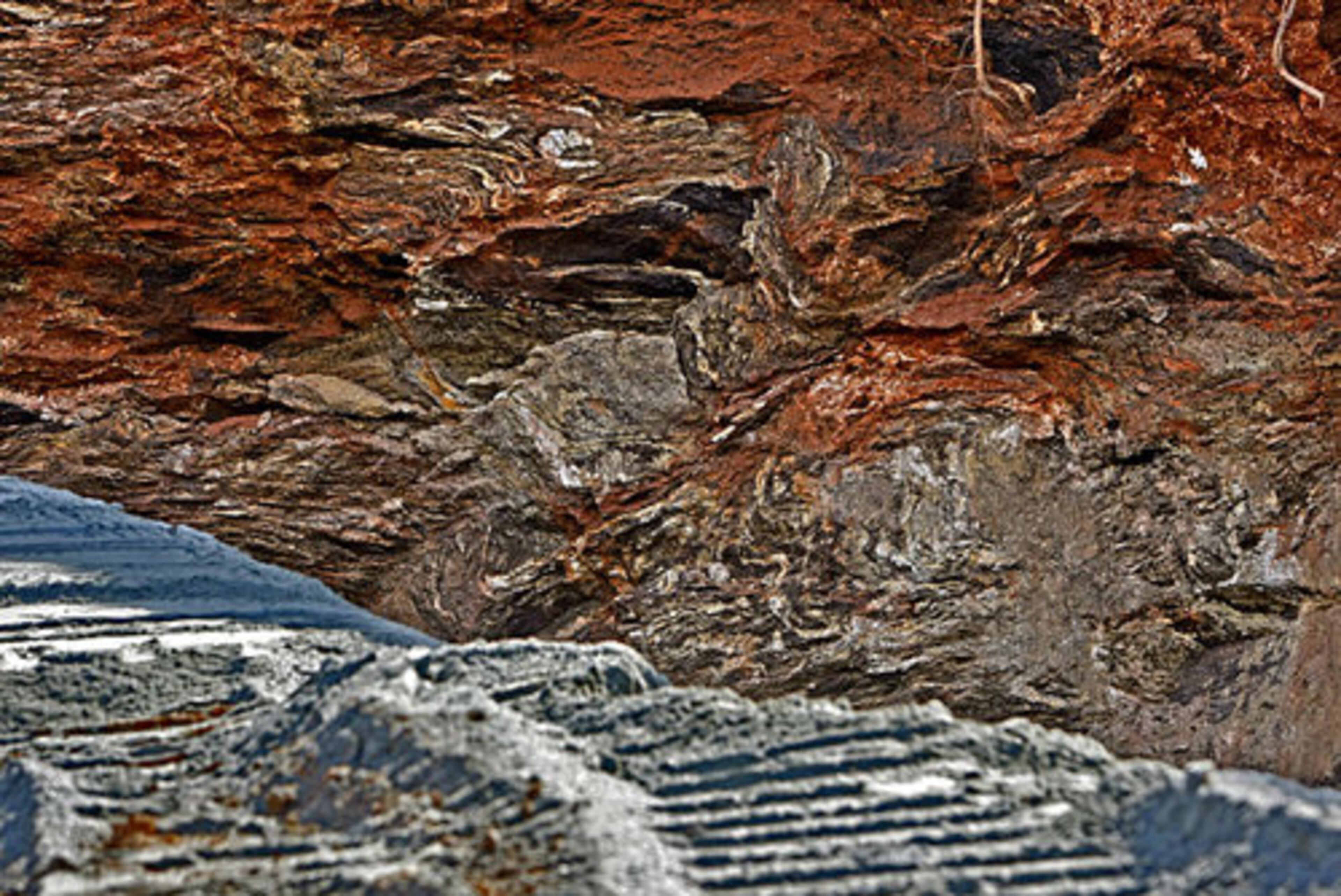 The rising foundation of A-10 manufactured granite (foreground) contrasted against the geological texture of the sink hole wall. Crews began working Thursday morning to fill in a massive sinkhole that swallowed a large chunk of a front yard in Marietta.
