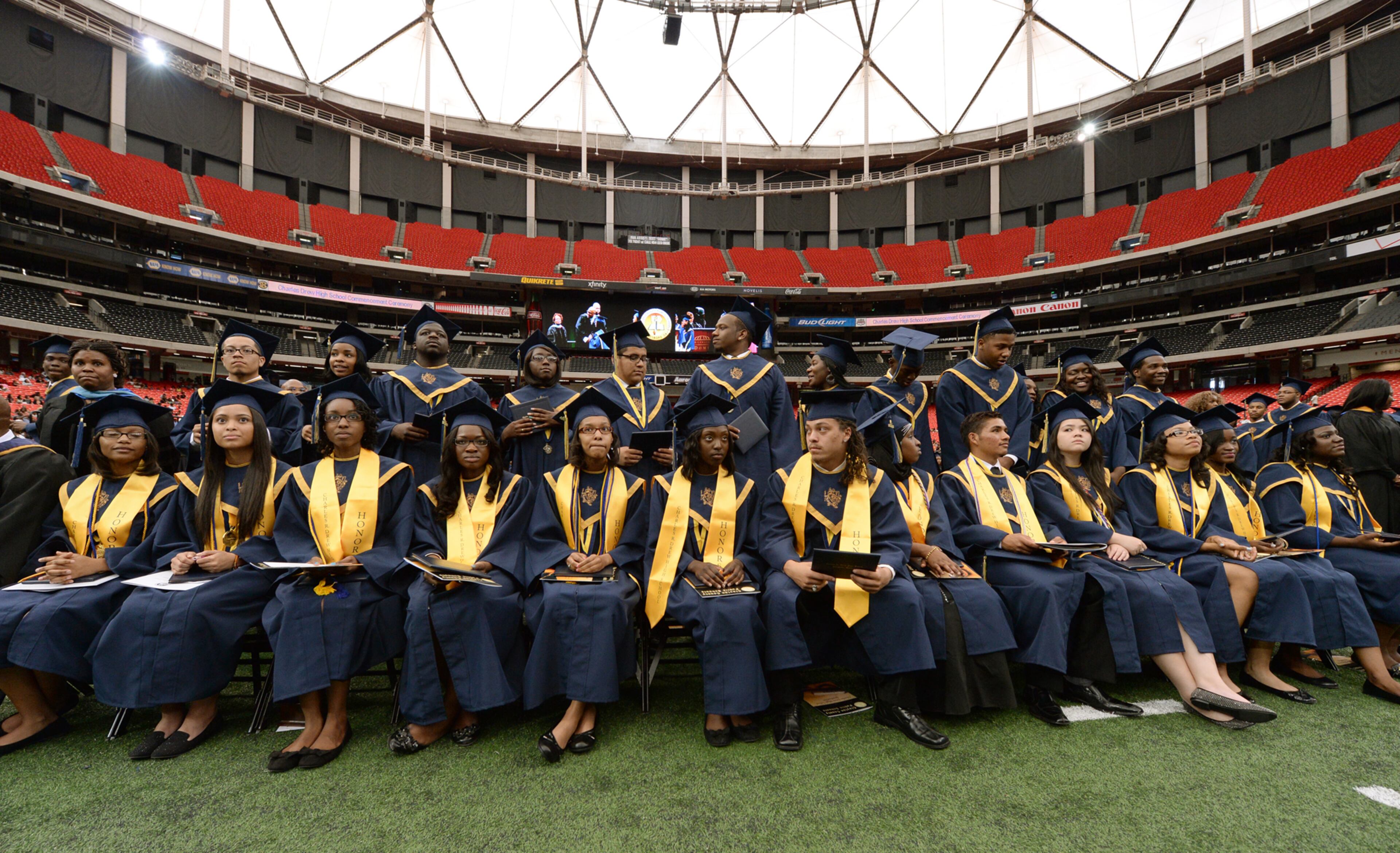 Students from Charles Drew High School wait for their names to be called during commencement exercise on Thursday, May 23, 2013 inside the Georgia Dome.