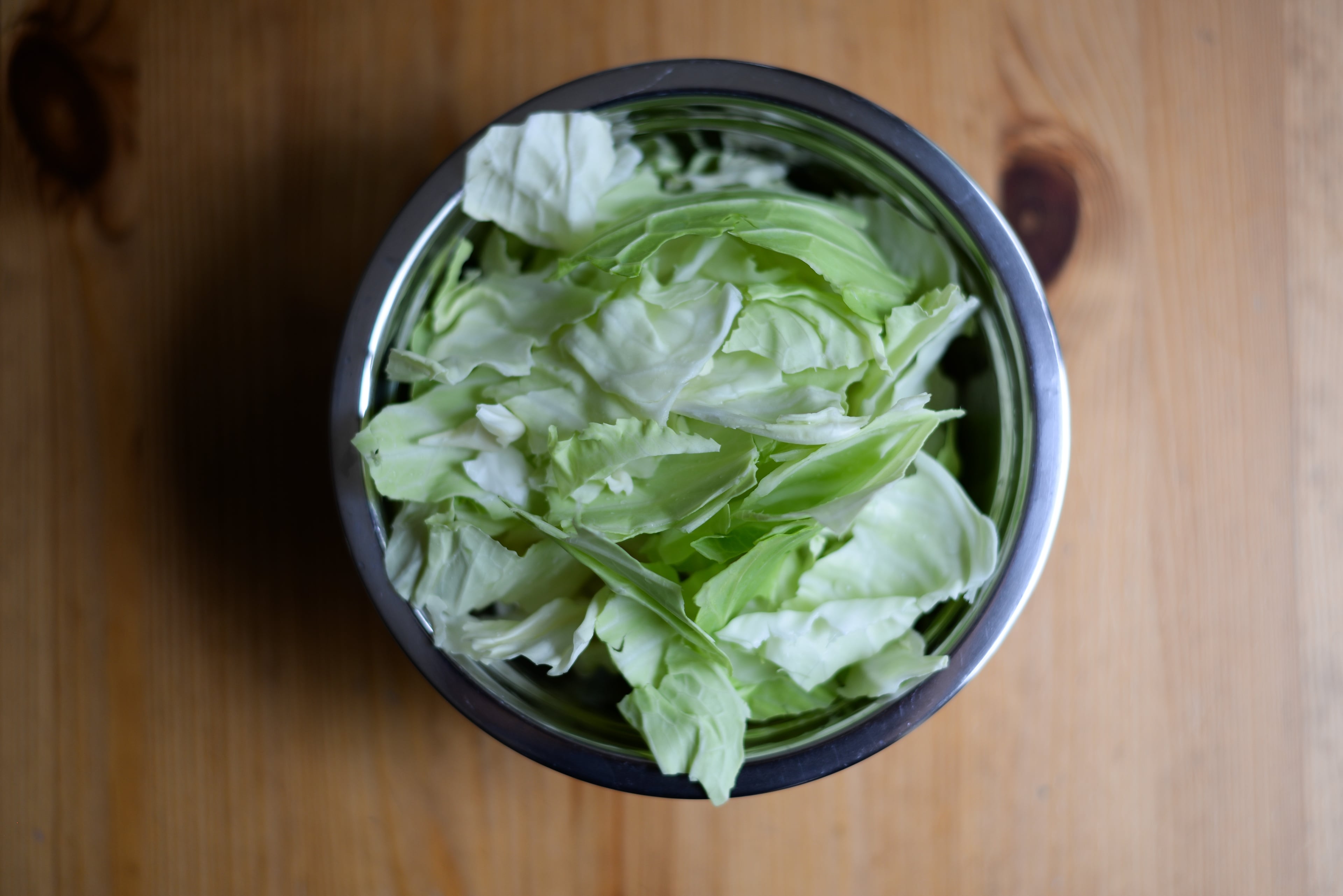 Step 1: Tear cabbage leaves into pieces by hand. Place in a salad spinner or strainer to rinse and dry. (Candy Hom for the AJC)