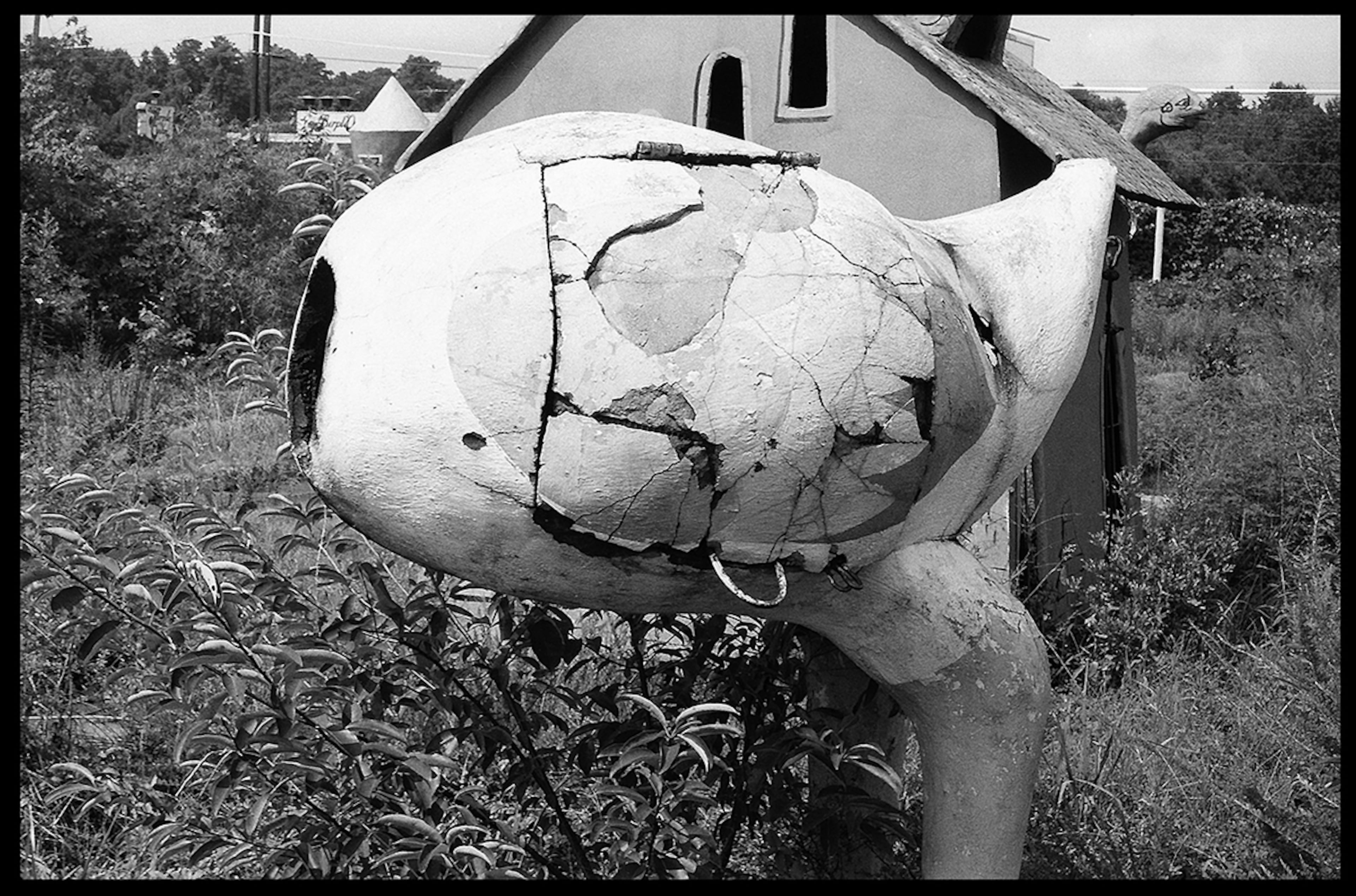 The bottom half of a big bird stands on the Funtown mini golf course. It looks like there's a hatch that opened on its side. (Clark J. Brown / Used with permission)