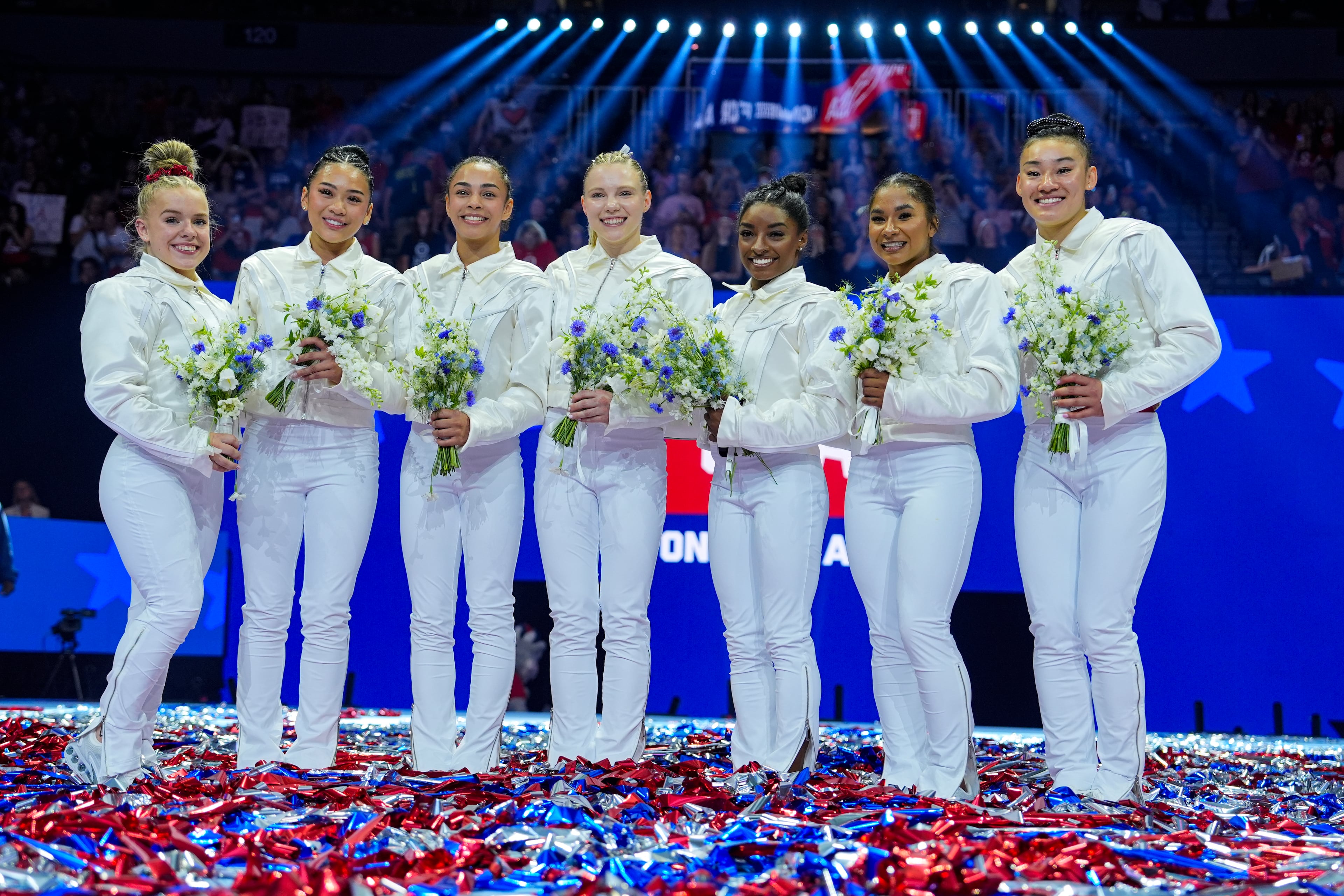 Joscelyn Roberson (left), Suni Lee, Hezly Rivera, Jade Carey, Simone Biles, Jordan Chiles and Leanne Wong (right) smile after they were named to the 2024 Olympic team at the United States Gymnastics Olympic Trials on Sunday, June 30, 2024, in Minneapolis. (Charlie Riedel/AP)