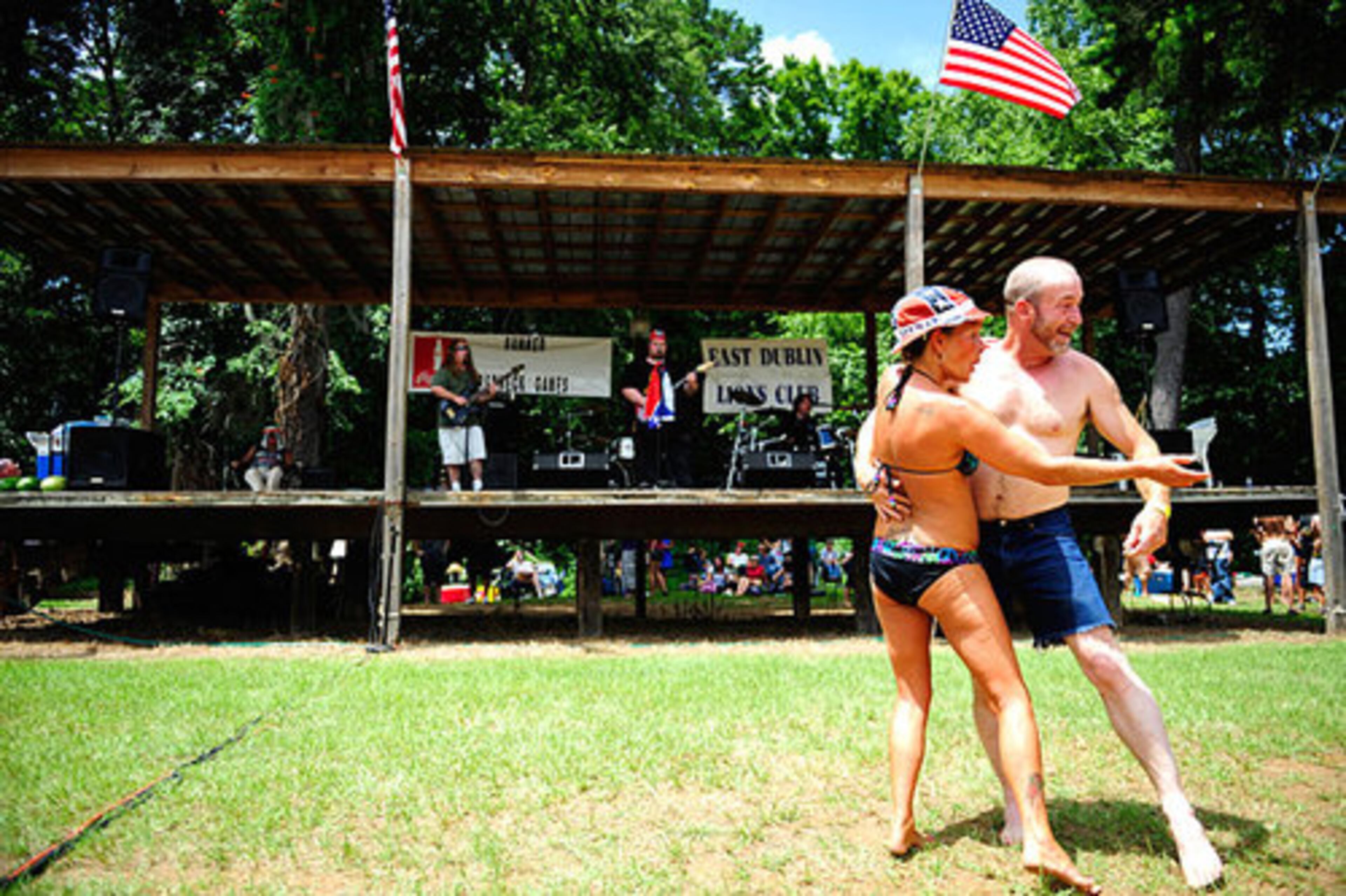 Rhonda and Billy Wood, of Milledgeville, beckon to a youngster (not pictured) to join in on their sultry dance to the live music.