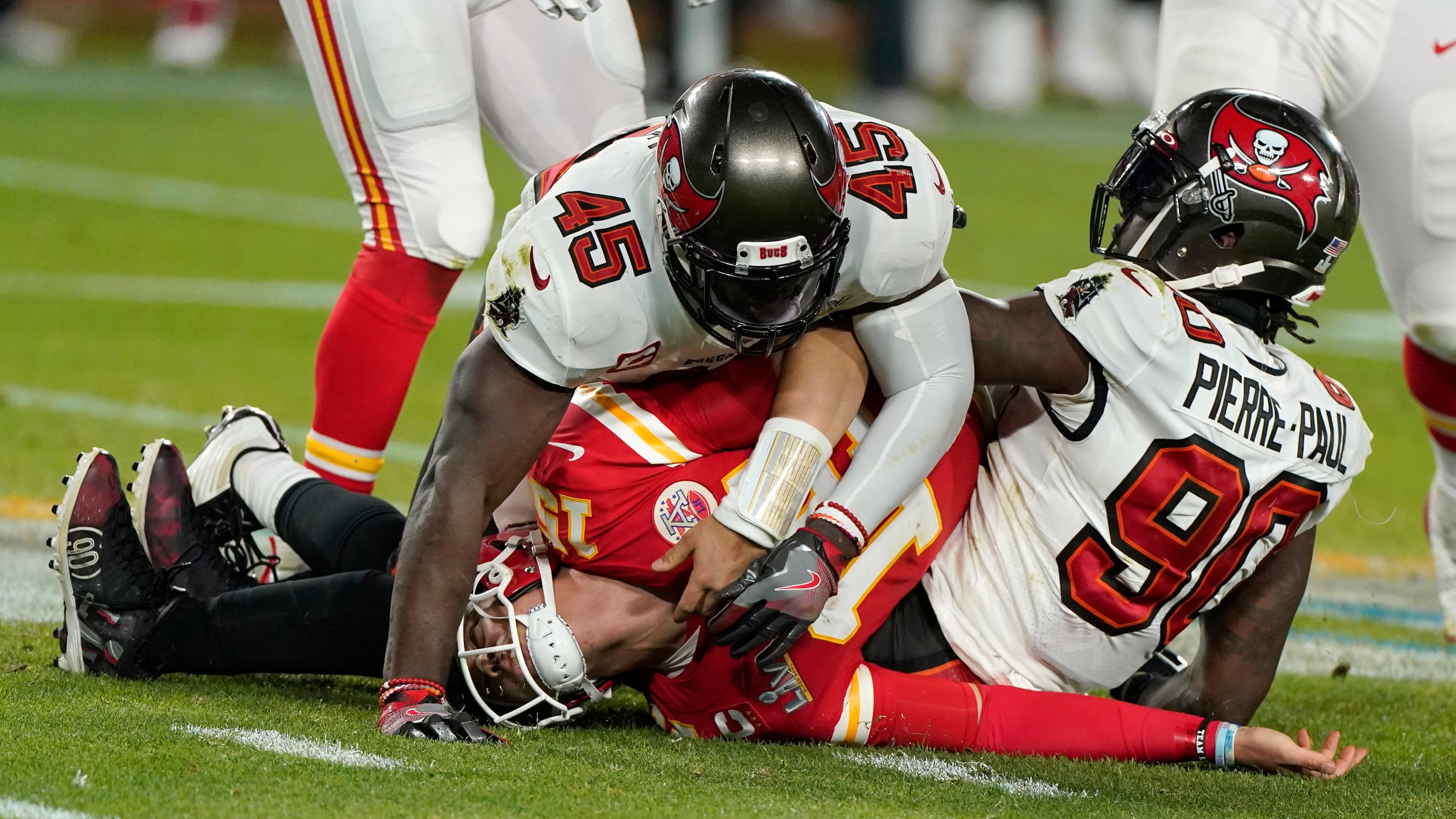 Kansas City Chiefs quarterback Patrick Mahomes (center) is tackled by Tampa Bay Buccaneers inside linebacker Devin White (45) and outside linebacker Jason Pierre-Paul (right) during the second half of Super Bowl 55 Sunday, Feb. 7, 2021, in Tampa, Fla. (Gregory Bull/AP)