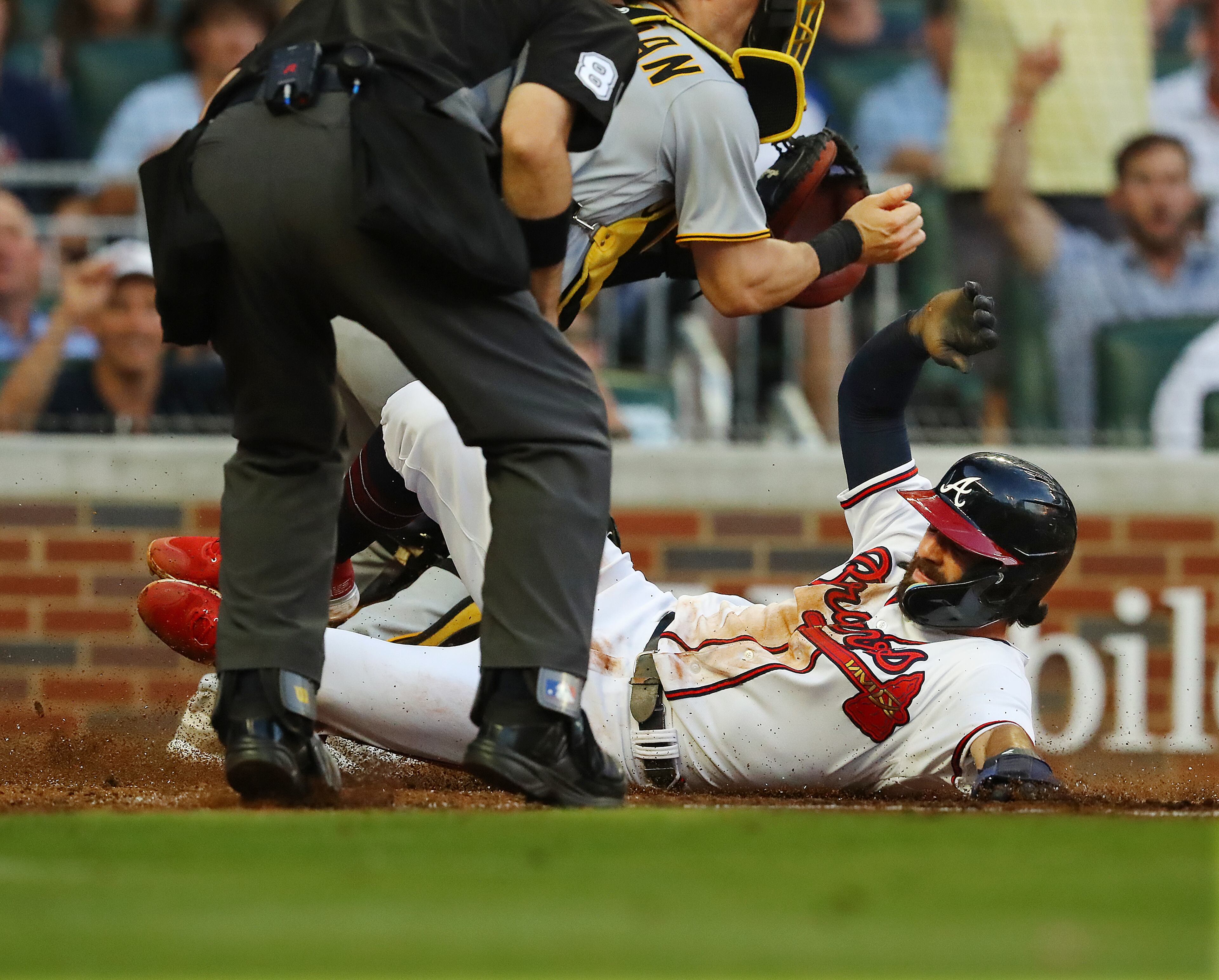 Braves shortstop Dansby Swanson slides home to score in the third inning of Thursday's win, the team's eighth straight.