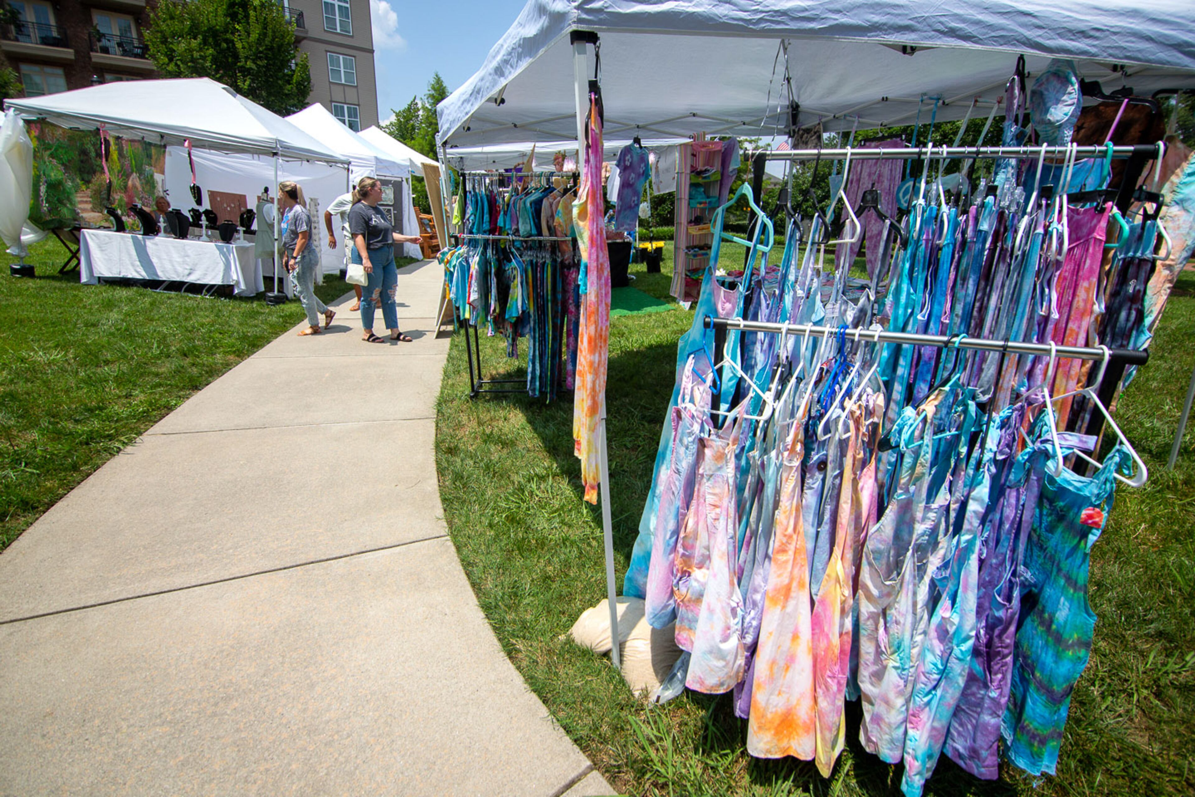 People walk among the artists' tents during Art in the Park at Brooke Street Park in Alpharetta on Sunday, July 25, 2021. (Photo: Steve Schaefer for The Atlanta Journal-Constitution)
