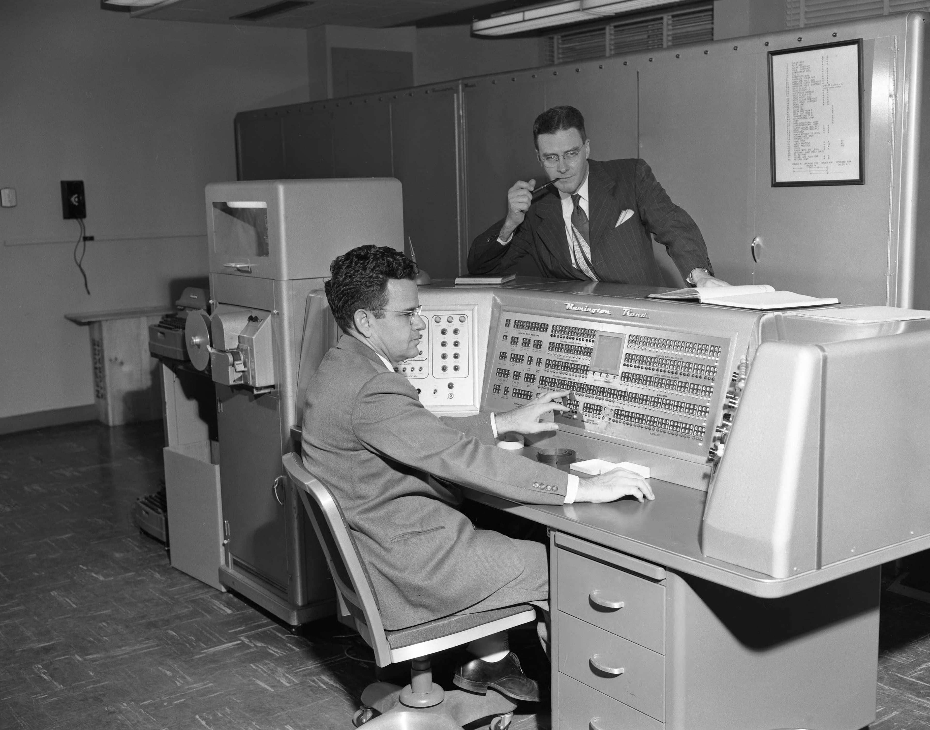 Programmer Woodrow W. Jackson, seated, and Dr. E. K. Ritter director of the Rich Electronic Computer Center at Georgia Tech on Oct. 24, 1955. The piece by Floyd E. Jillson was titled “The Electric Brain.”