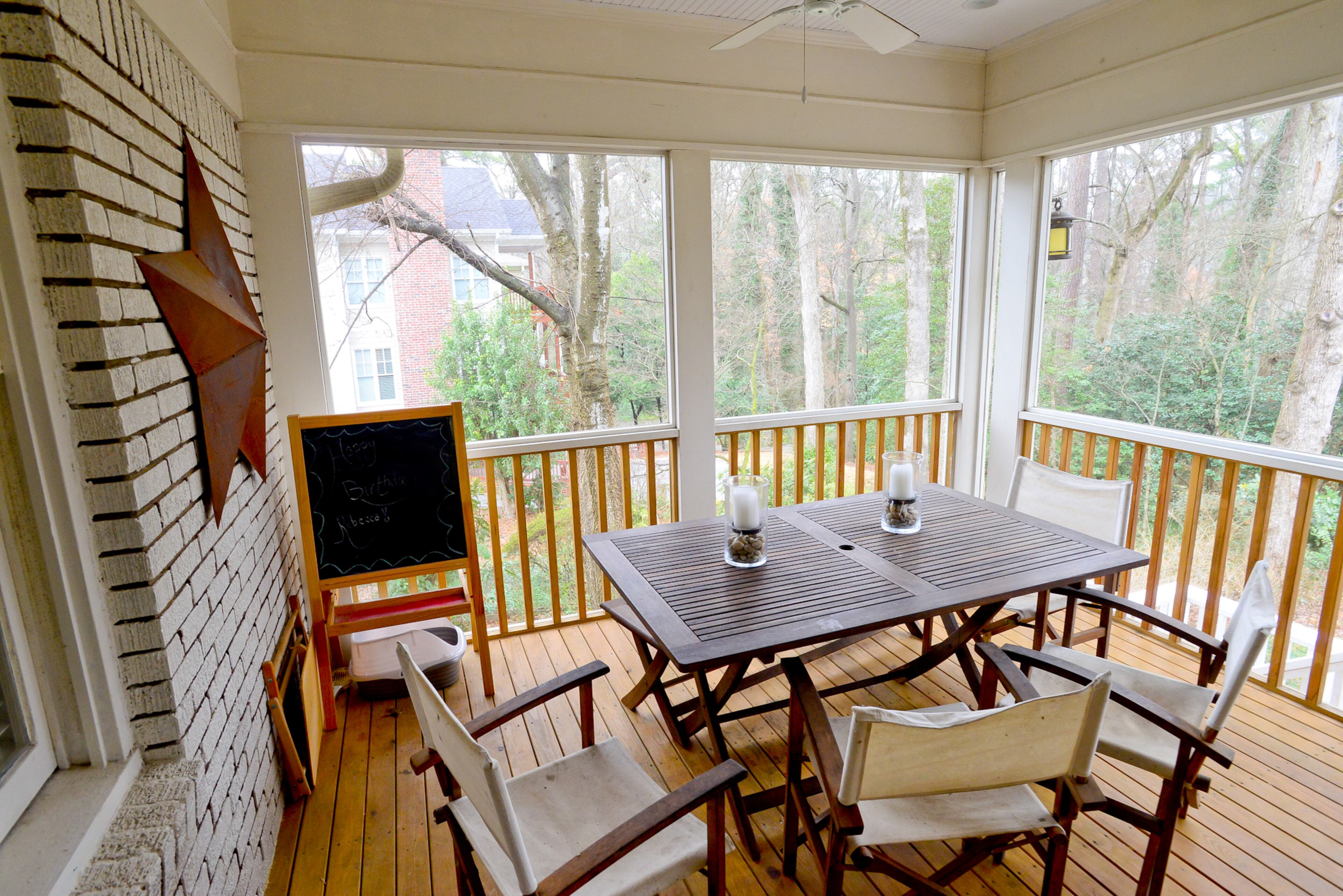 During the warm months, the new screened-in porch is a favorite spot for the Buckhead family. The table and chairs are from World Market.