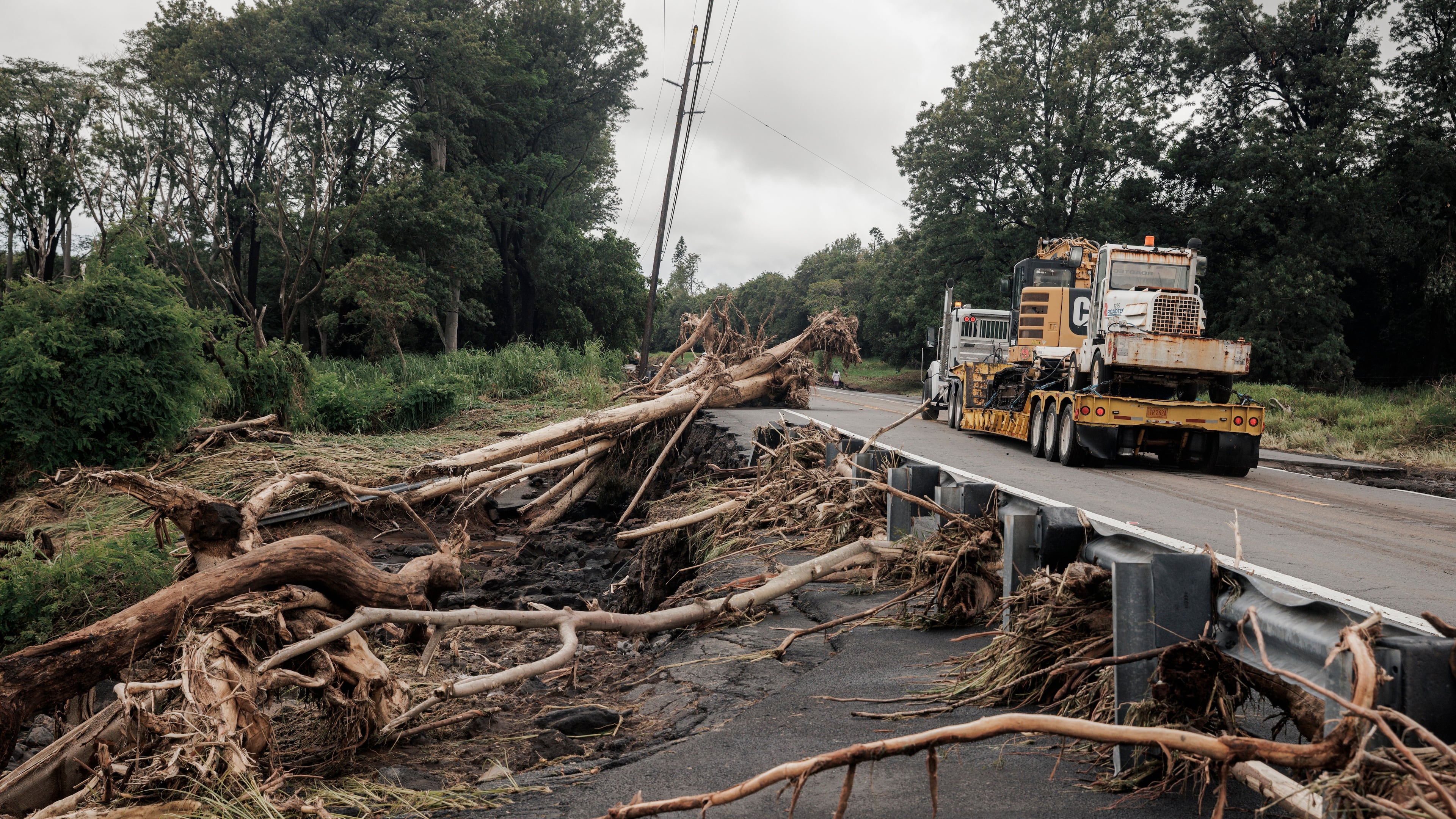 Debris is seen along Hawaiʻi Belt Road near Pahala, Hawaii, Sunday, Aug. 16, 2026, after a severe weather system went through the area. (Stephen Lam/San Francisco Chronicle via AP)