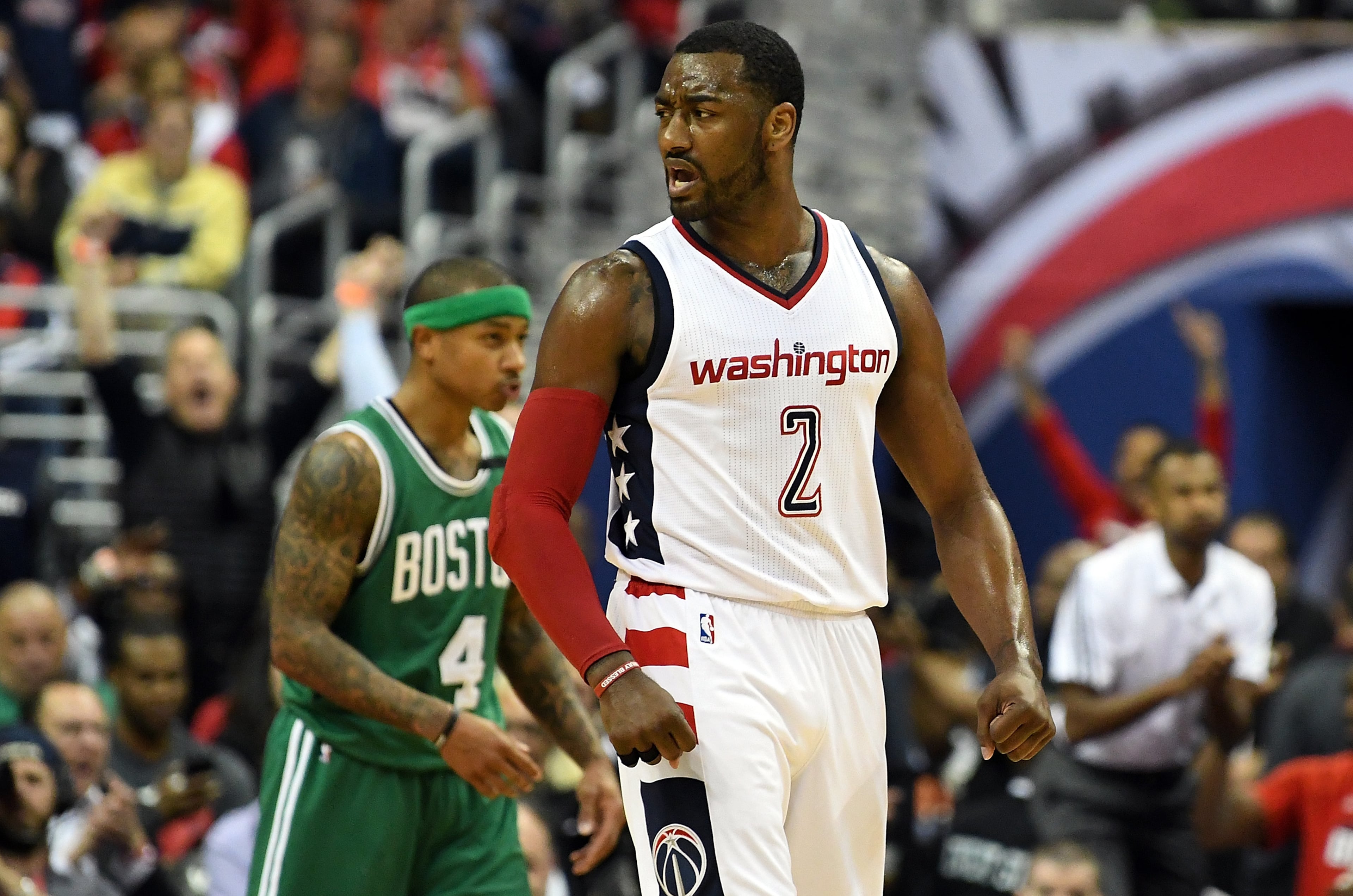 John Wall celebrates after a basket against the Celtics.