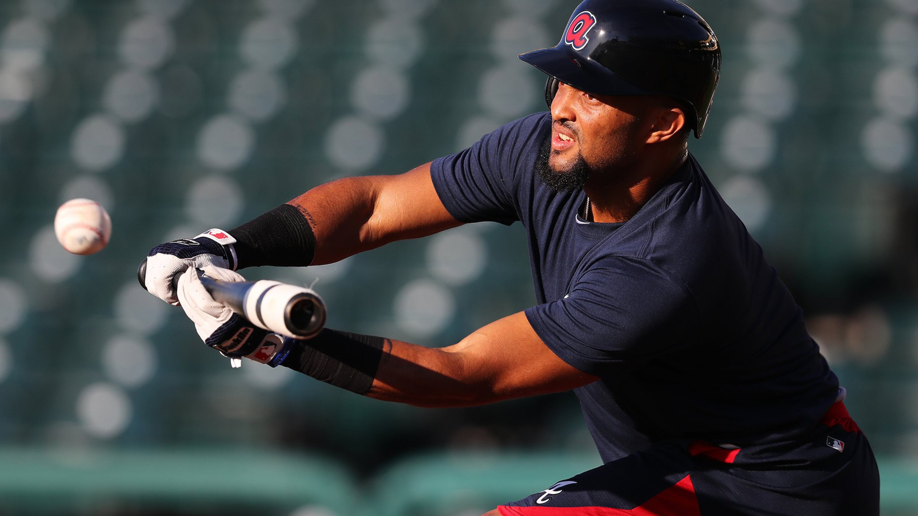 Braves utility player Emilio Bonifacio works on bunting during an early spring-training workout. He was told Tuesday that he made the team. (Curtis Compton/ccompton@ajc.com)