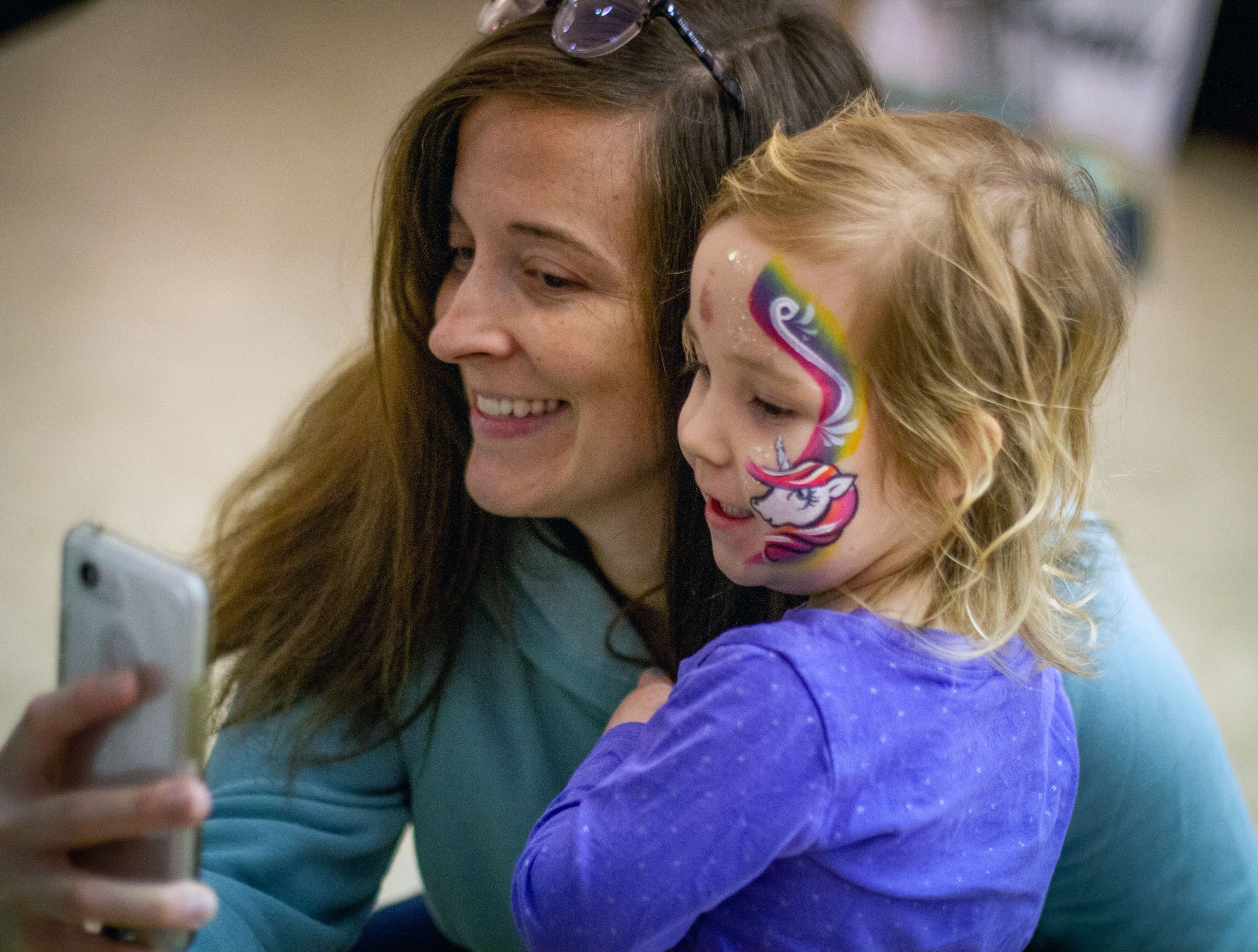 Katie Bale takes a photograph with her daughter Alice with her unicorn face painting during the 42 annual Groundhog Day Jugglers Festival at the Yaarab Shrine Center in Atlanta on Saturday, February 8, 2020. STEVE SCHAEFER / SPECIAL TO THE AJC