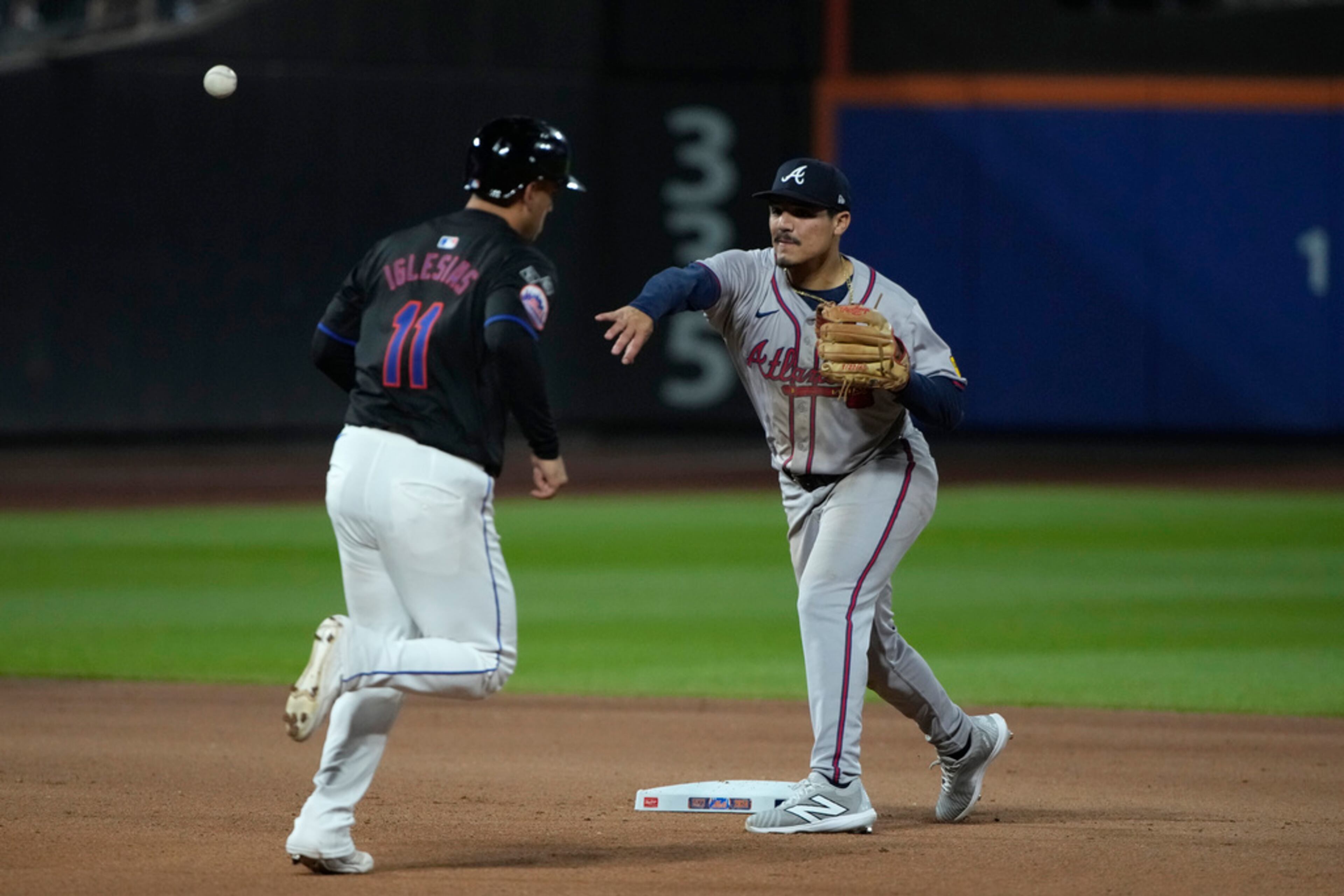 Atlanta Braves' second baseman Nacho Alvarez Jr., right, throws to first baseman Matt Olson (not shown) to put out Francisco Alvarez (not shown). (AP Photo/Pamela Smith)