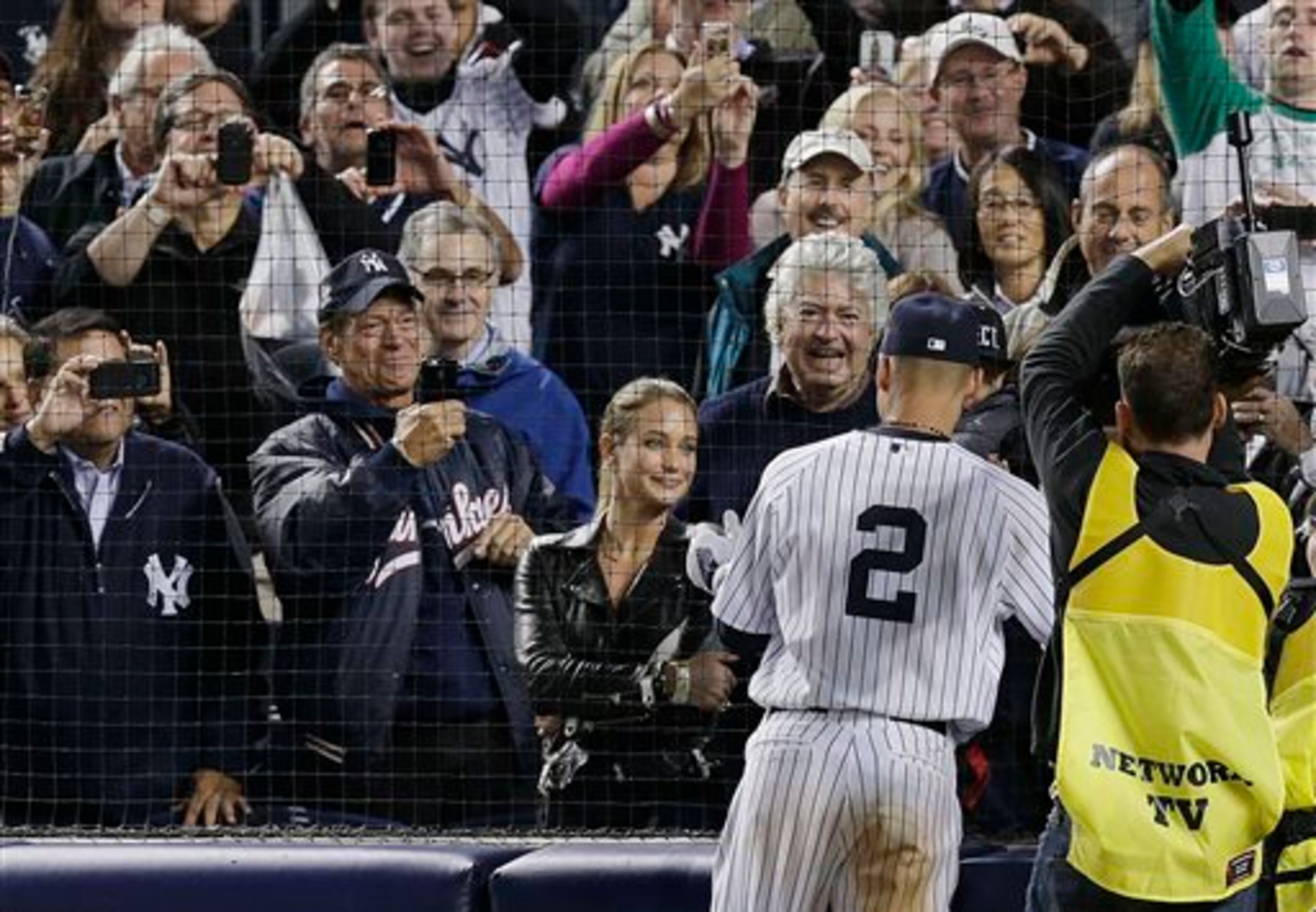 New York Yankees shortstop Derek Jeter (2) greets his girlfriend, Hannah Davis, and family members after playing in his last home career baseball game at Yankee Stadium, against the Baltimore Orioles on Thursday, Sept. 25, 2014, in New York. Jeter drove in the winning run in the ninth inning to propel the Yankees to a 6-5 win. (AP Photo/Julie Jacobson)
