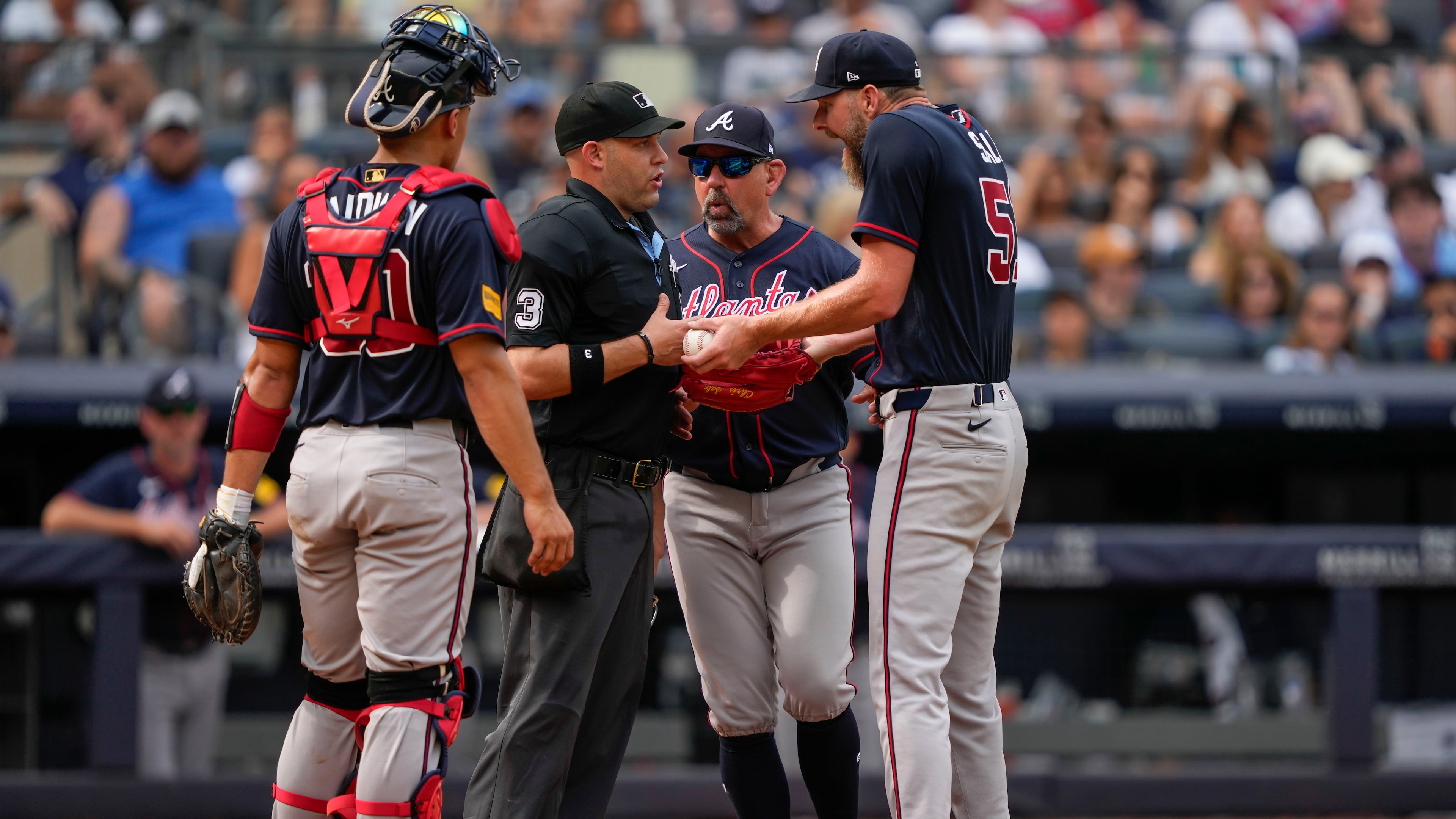 Atlanta Braves pitcher Chris Sale, right, argues with home plate umpire Dan Merzel, second left, during the fifth inning of a baseball game against the New York Yankees, Saturday, Aug. 8, 2026, in New York. (AP Photo/Yuki Iwamura)