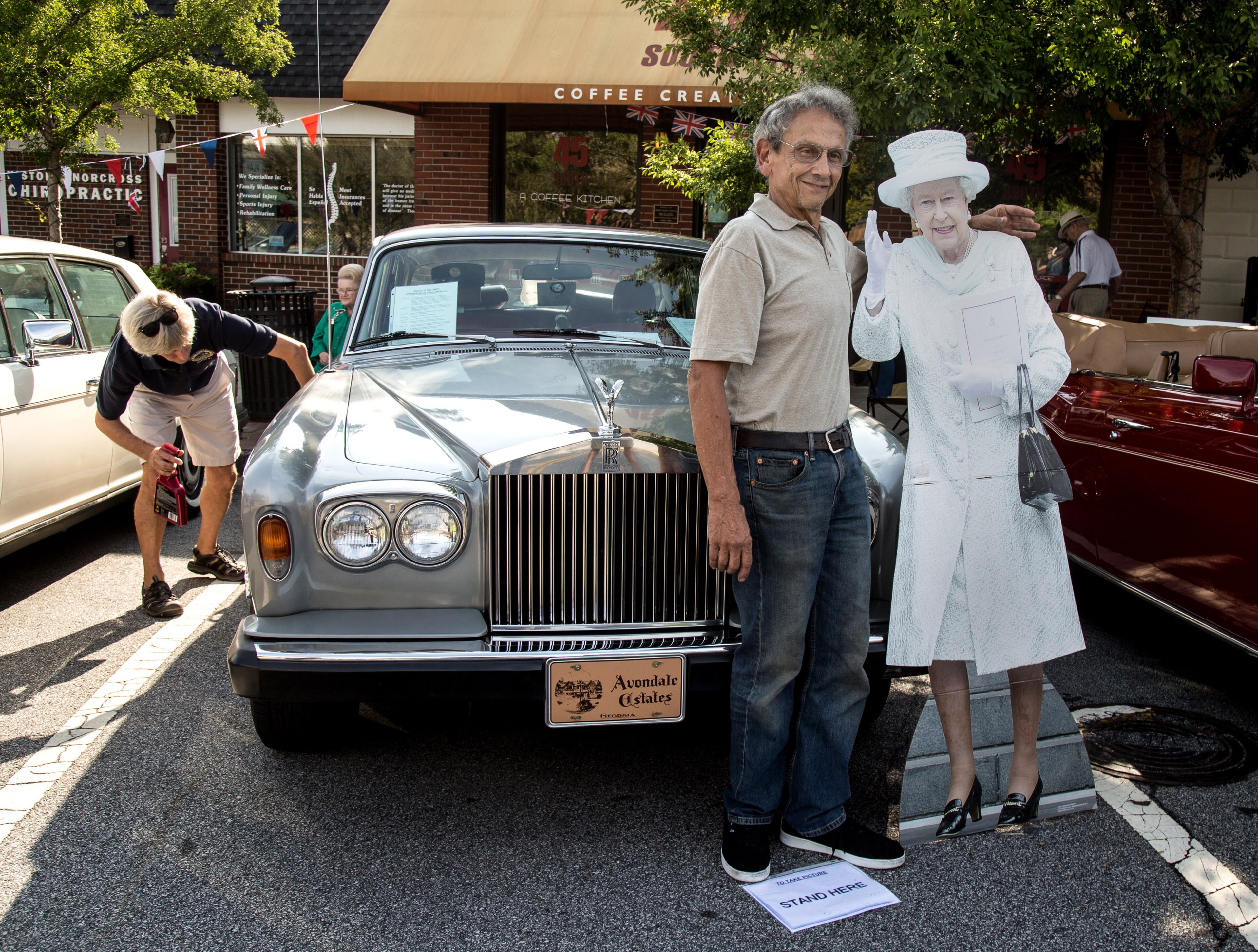 Robert Russo gets his photograph taken with a cardboard cutout of Queen Elizabeth while standing in front of a 1978 Rolls-Royce Silver Shadow II during the 8th annual Atlanta British Car Fayre in downtown Norcross on Saturday, Sept. 8, 2018. The British Car Fayre featured more than 400 British automobiles and motorcycles. (Photo: STEVE SCHAEFER / SPECIAL TO THE AJC)