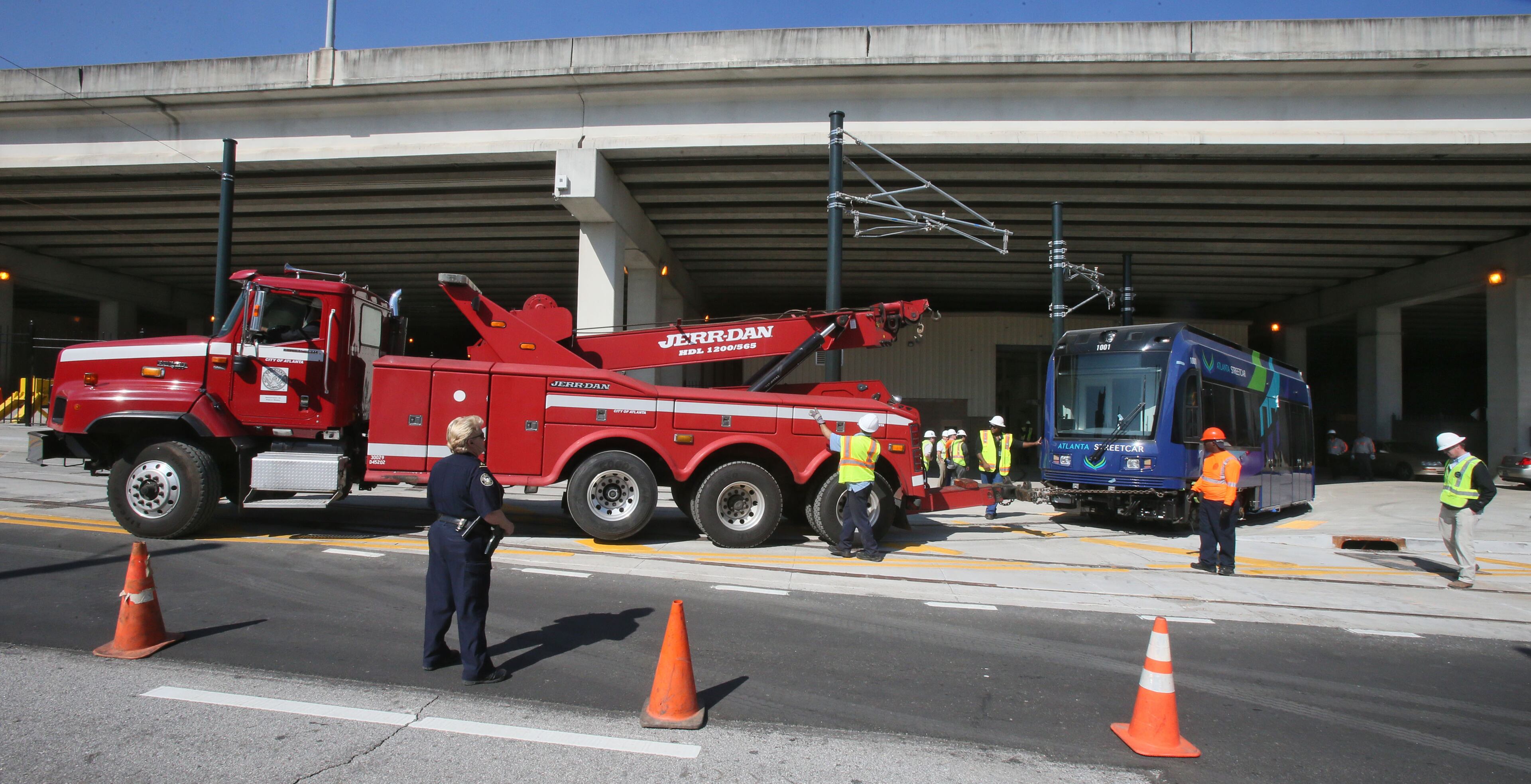 Workers first used a tow truck to move the new streetcar out of the maintenance facility.