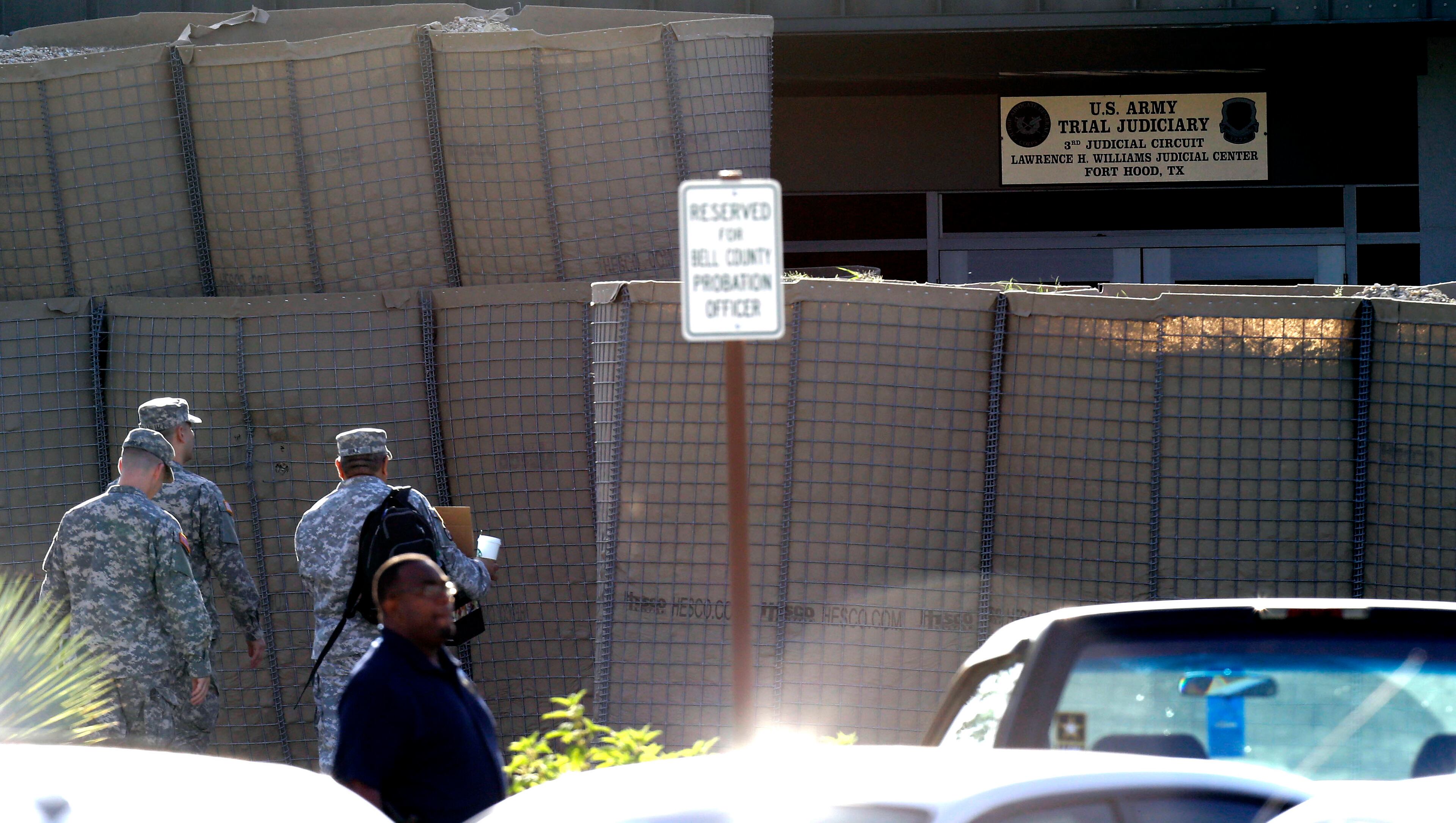 Soldiers enter the courthouse where the court-martial of Maj. Nidal Hasan is taking place Tuesday, Aug. 6, 2013, at Fort Hood. After years of delays, the trial of the man accused of carrying out the Fort Hood shooting is starting, with Hasan representing himself against charges of murder and attempted murder for the 2009 attack that left 13 people dead on the Army post.