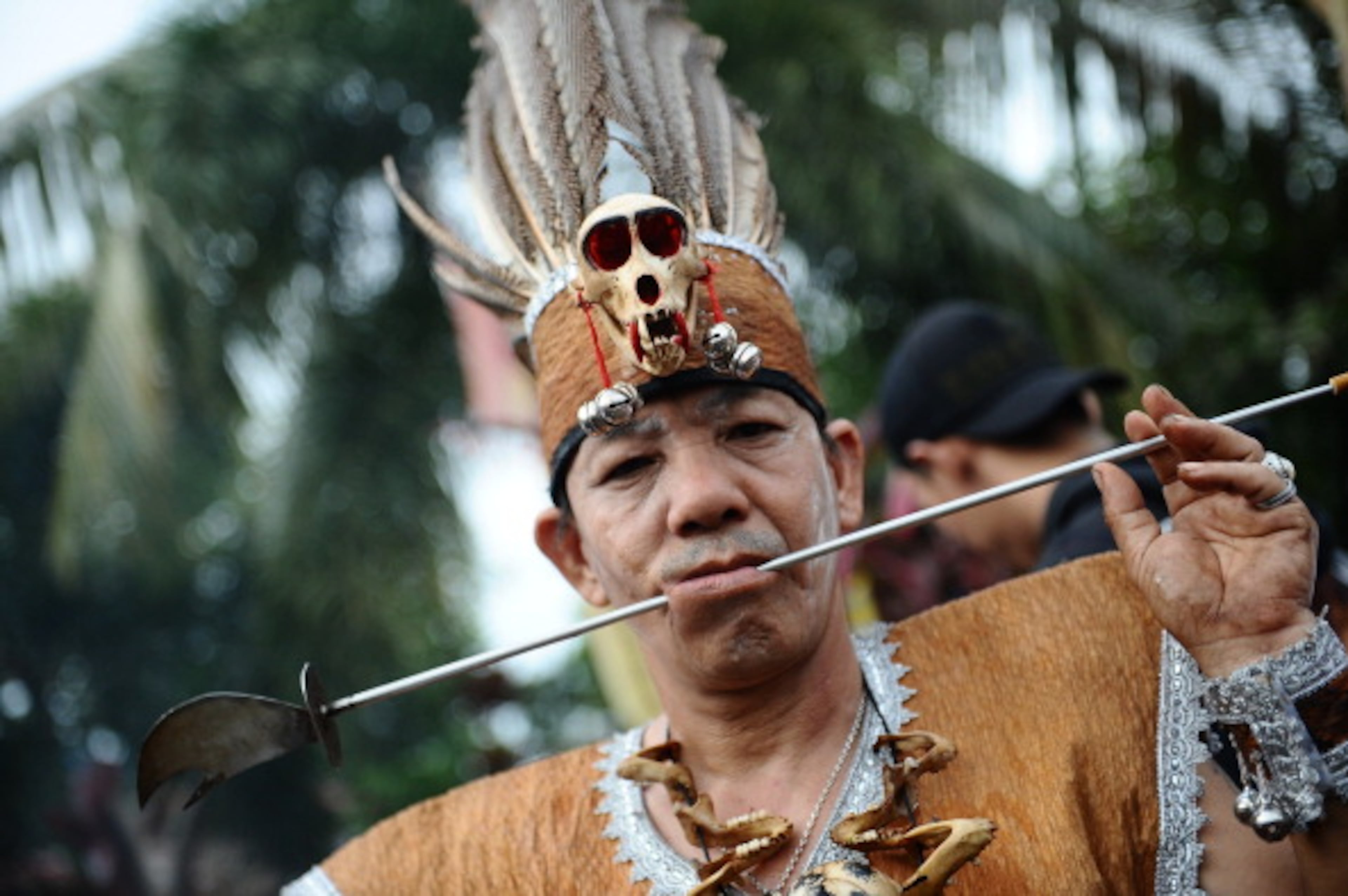 SINGKAWANG, KALIMANTAN, INDONESIA - FEBRUARY 14: A Tatung pierces metal needles trough his cheeks during Tatung Festival as part of Cap Go Meh celebration on February 14, 2014 in Singkawang, Kalimantan, Indonesia. The ancient art of Tatung, performed as part of the Cap Go Meh Festival, is believed to call upon positive spirit who help to dispel the bad spirits that may affect people's lives. Cap Go Meh Festival also know as Lantern Festival is celebrated in the 15th day of Chinese Lunar Year and marks the end of the Chinese New Year celebrations. (Photo by Robertus Pudyanto/Getty Images)