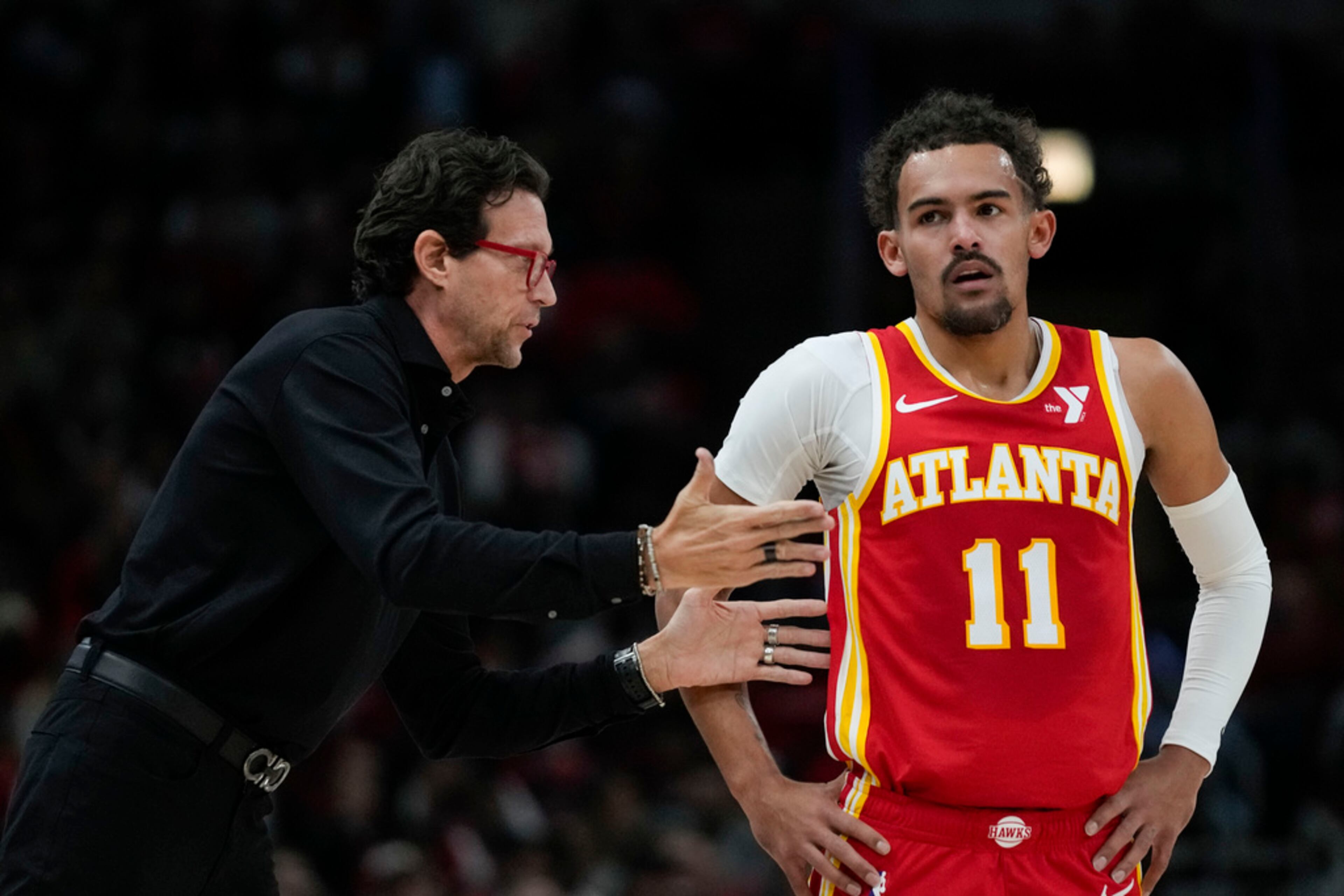 Atlanta Hawks coach Quin Snyder talks to guard Trae Young during the first half of the team's NBA basketball game against the Chicago Bulls on Tuesday, Dec. 26, 2023, in Chicago. (AP Photo/Erin Hooley)