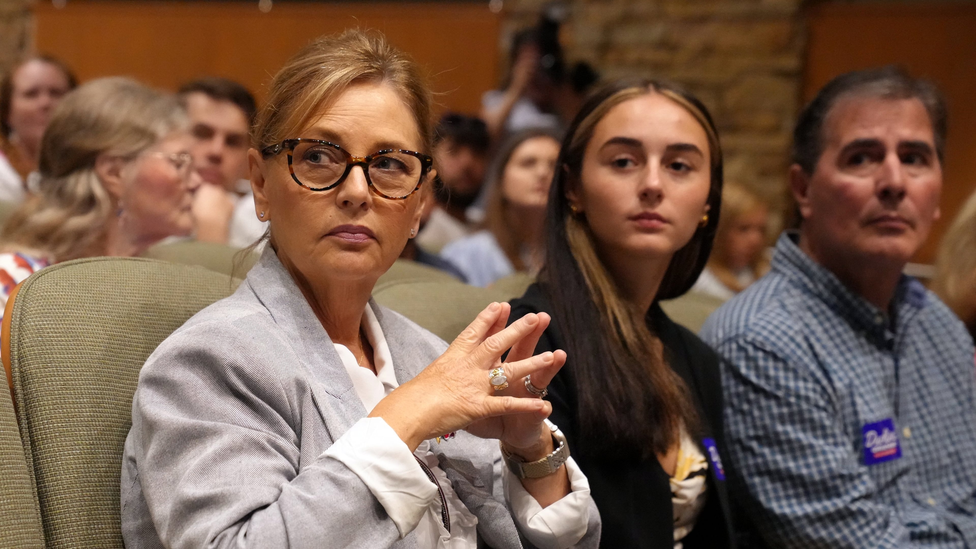 Sen. Darline Graham, R-S.C., from left, seated alongside daughter Nicole Nordone and husband Larry Nordone, looks on as a South Carolina Republican Senate candidate stump event gets underway ahead of the special GOP primary to replace her late brother, Sen. Lindsey Graham, R-S.C., Saturday, Aug. 1, 2026, in Lexington, S.C. (AP Photo/Meg Kinnard)