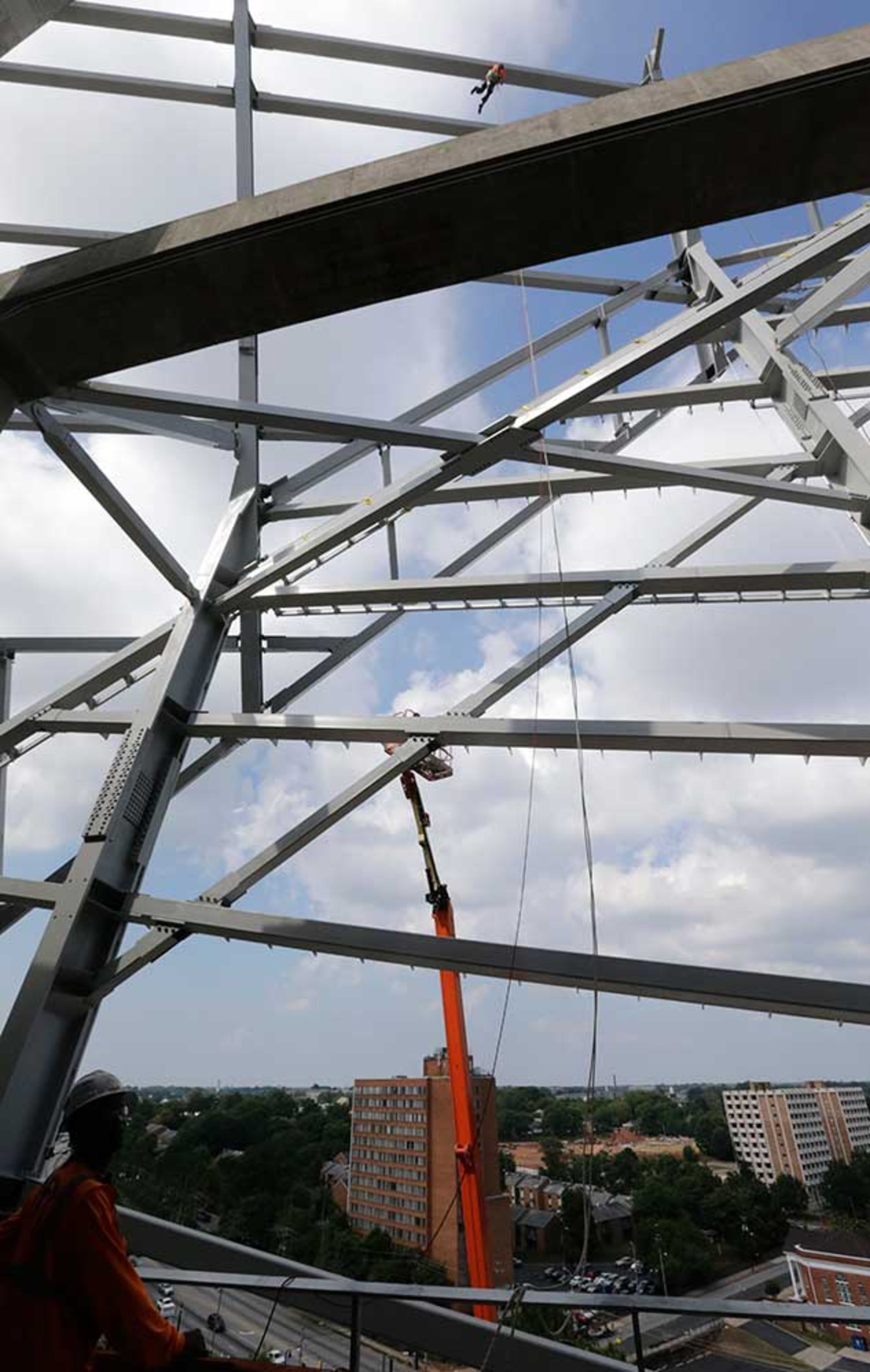 Looking outward to the west from the upper concourse, erection of the facade steel is visible around the exterior of the stadium.