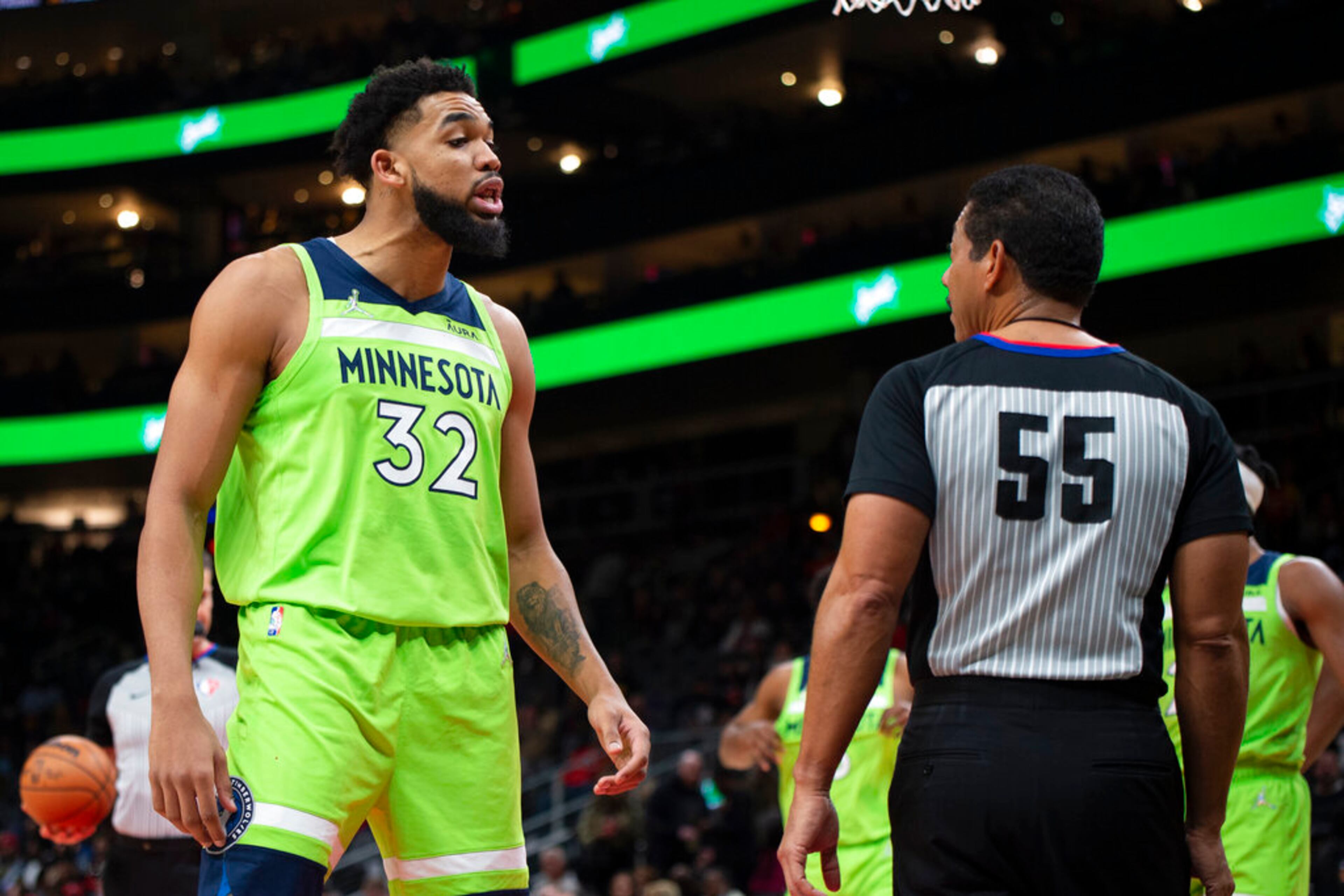 Minnesota Timberwolves center Karl-Anthony Towns (32) talks to referee Bill Kennedy during the first half of the team's NBA basketball game against the Atlanta Hawks on Wednesday, Jan. 19, 2022, in Atlanta. (AP Photo/Hakim Wright Sr.)