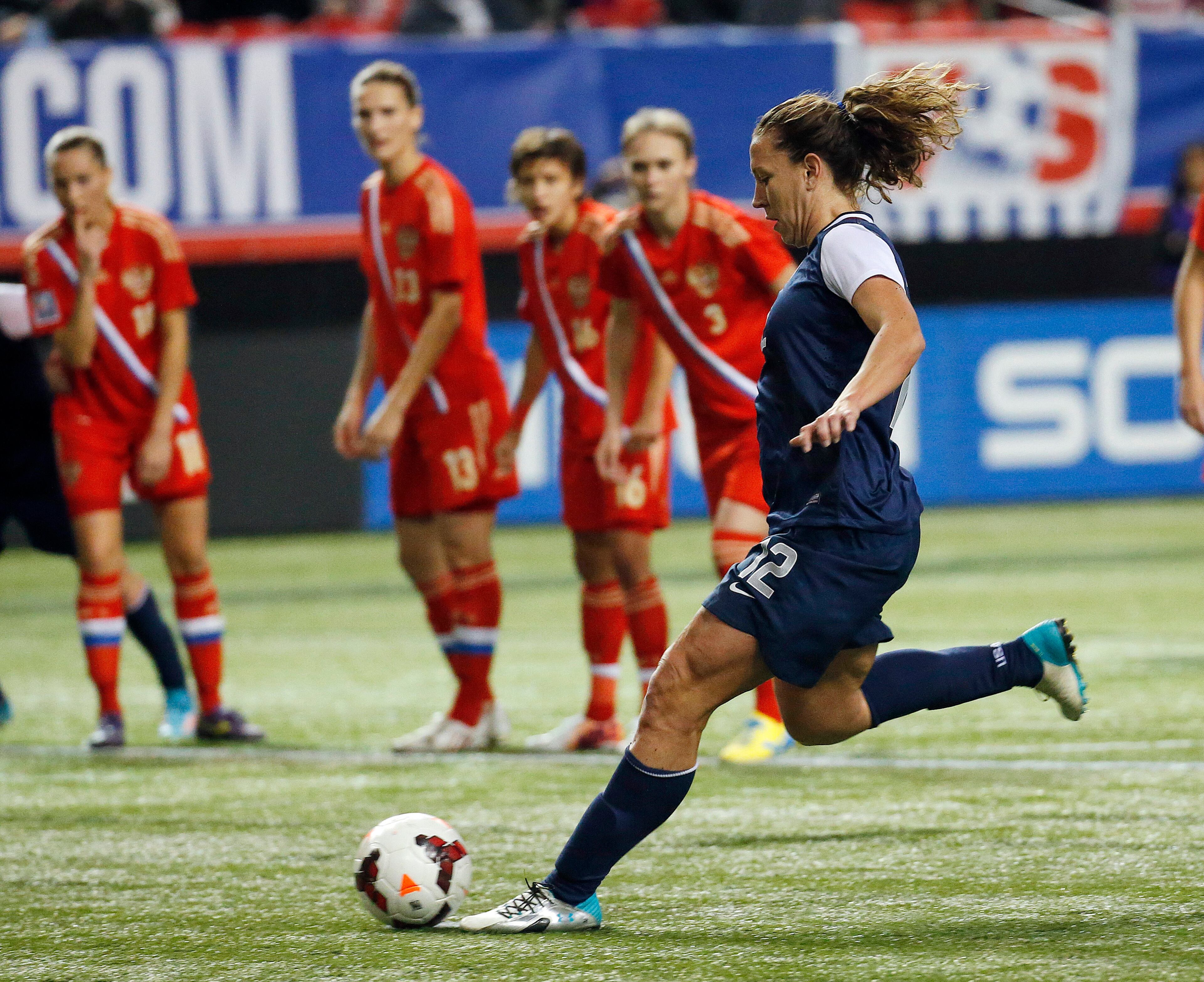 United States' Lauren Holiday (12) scores on a penalty kick in an exhibition soccer match against Russia on Thursday, Feb. 13, 2014, in Atlanta. The United States won 8-0.